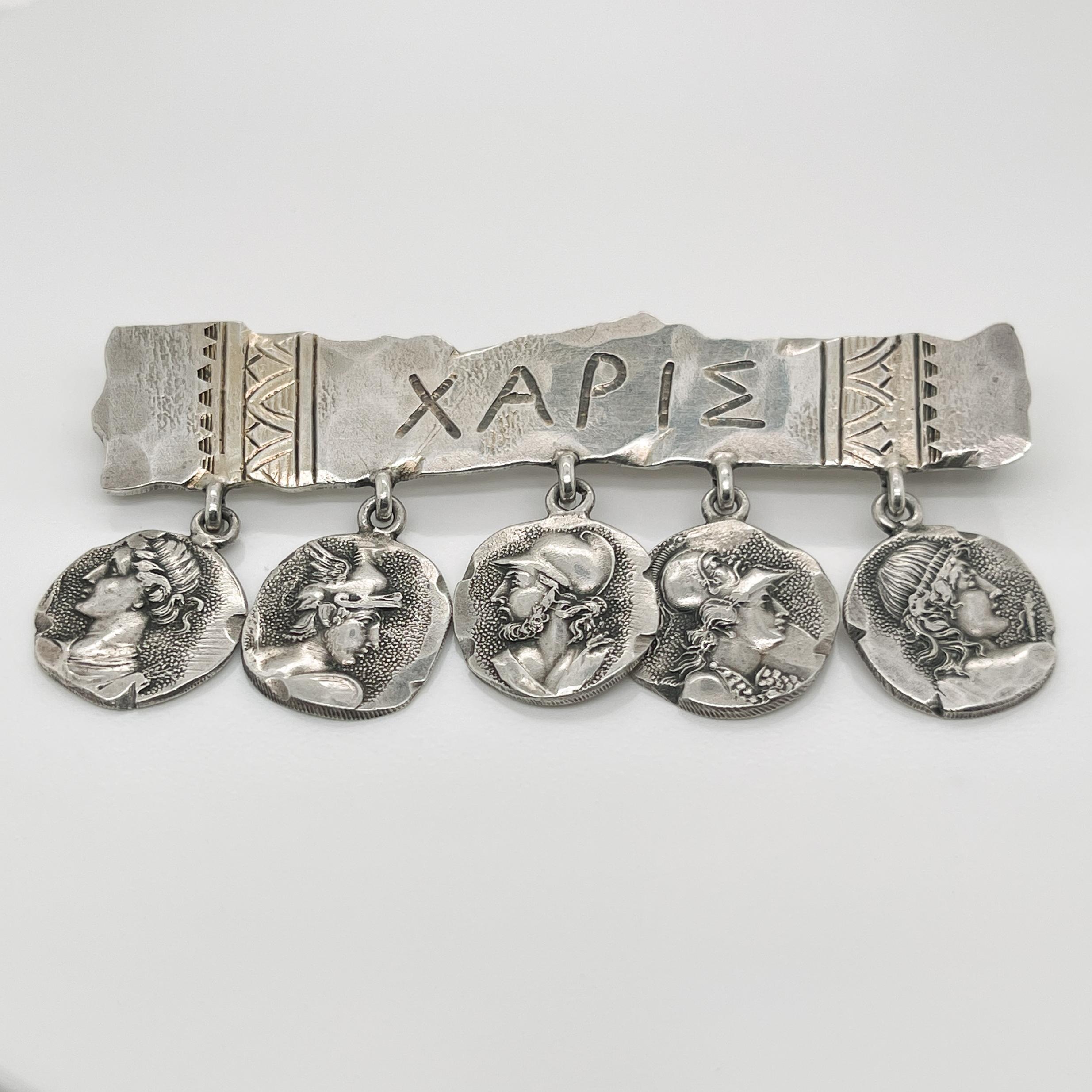 A very fine George Shiebler Etruscan brooch.

In sterling silver.

With five medallions suspended from a bar stamped XAPIE.

Simply a wonderful piece of American Aesthetic Movement jewelry!

Date:
19th Century

Overall Condition:
It is in overall