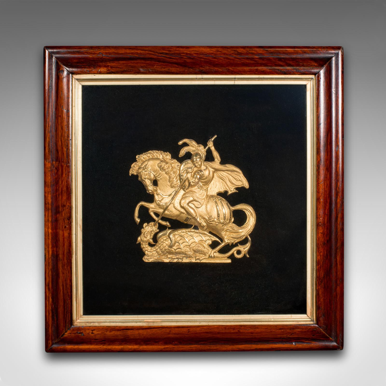This is an antique George & the Dragon display plaque. An English, gilt metal and beech framed decorative relief, dating to the Regency period and later, circa 1820.

As one of the world's most venerated saints, St George of Lydda - today, South