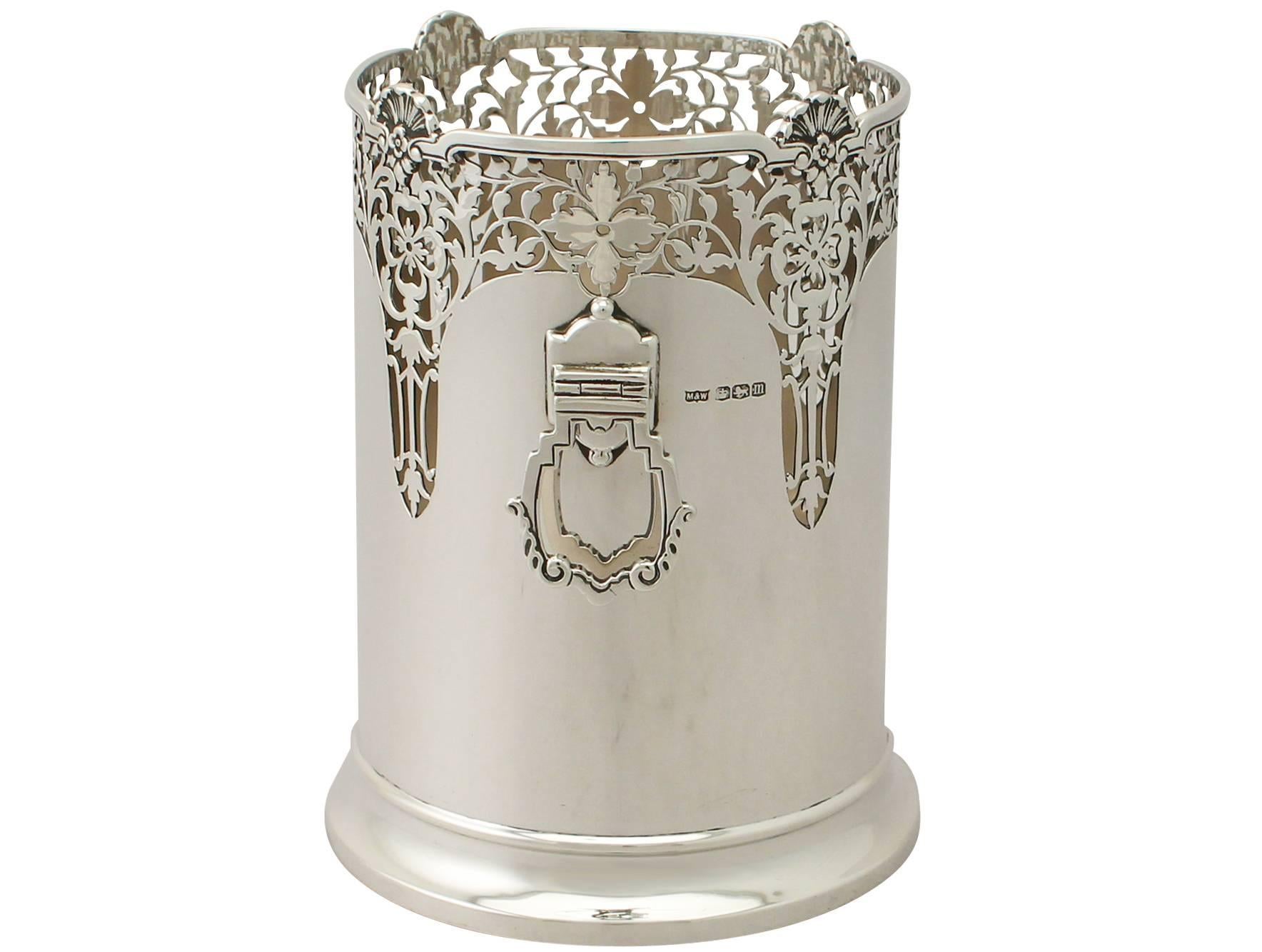 An exceptional, fine and impressive antique George V English sterling silver bottle coaster in the Art Deco style; an addition to our ornamental silverware collection.

This exceptional antique George V sterling silver bottle coaster has a plain
