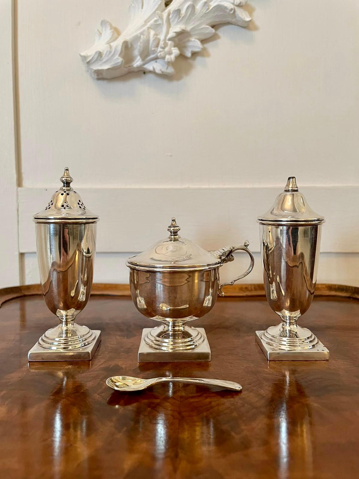 Antique George V cased four piece solid sterling silver condiment set stamped by Viners, Sheffield 1934 comprising of a mustard pot with blue glass liner, mustard spoon and pair of pepperettes. All in solid silver of 5oz/12dwt contained in its