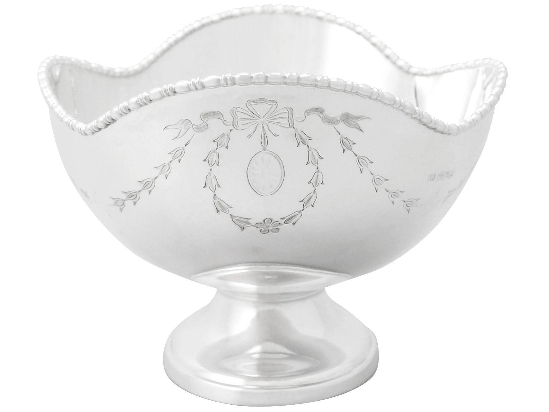 A fine antique George V English sterling silver fruit dish; part of our sterling silver collection.

This antique George V sterling silver fruit dish has a plain rounded oval form onto an oval spreading foot.

The surface of this antique dish is