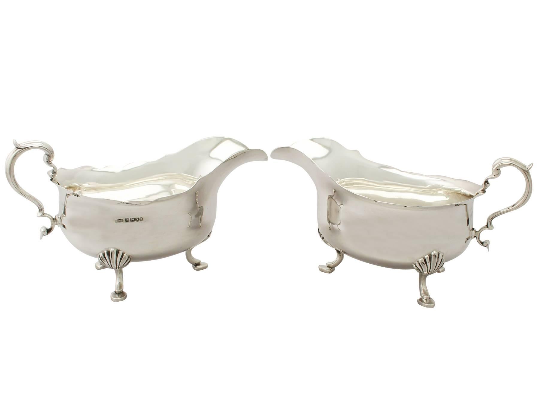 An exceptional, fine and impressive, large pair of antique George V English sterling silver sauceboats made in the George III style, an addition to our dining silverware collection.

These exceptional antique George V sterling silver