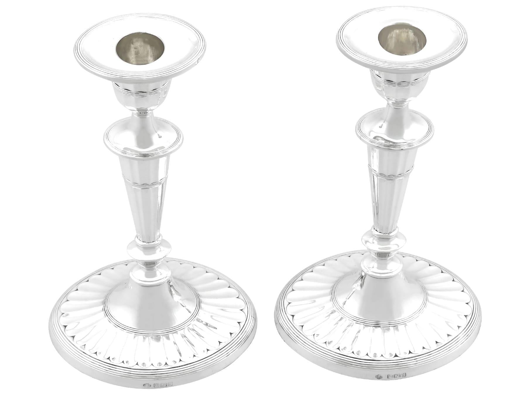 An exceptional, fine and impressive pair of antique George V English sterling silver Adams style candlesticks; an addition to our antique silverware collection.

These exceptional, fine and impressive antique George V sterling silver candlesticks