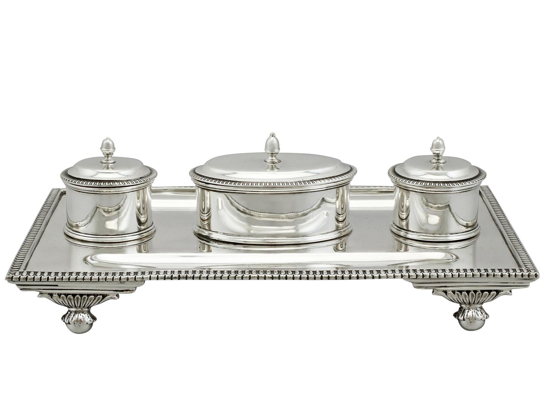 An exceptional, fine and impressive antique George V English sterling silver desk Standish; an addition to our ornamental silverware collection.

This exceptional antique silver desk Standish, in sterling standard, has a rectangular form.

This