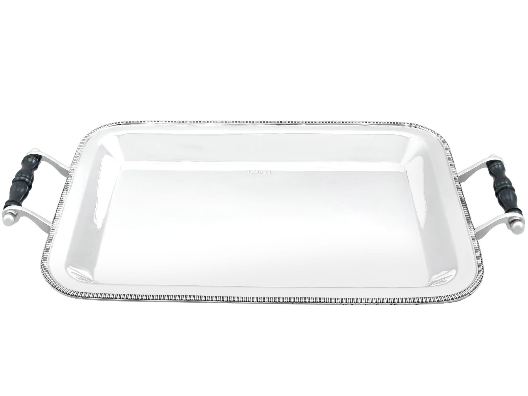 An exceptional, fine and impressive antique George V English sterling silver drinks tray; an addition to our ornamental silverware collection.

This exceptional antique George V sterling silver drinks tray has a rectangular form with rounded