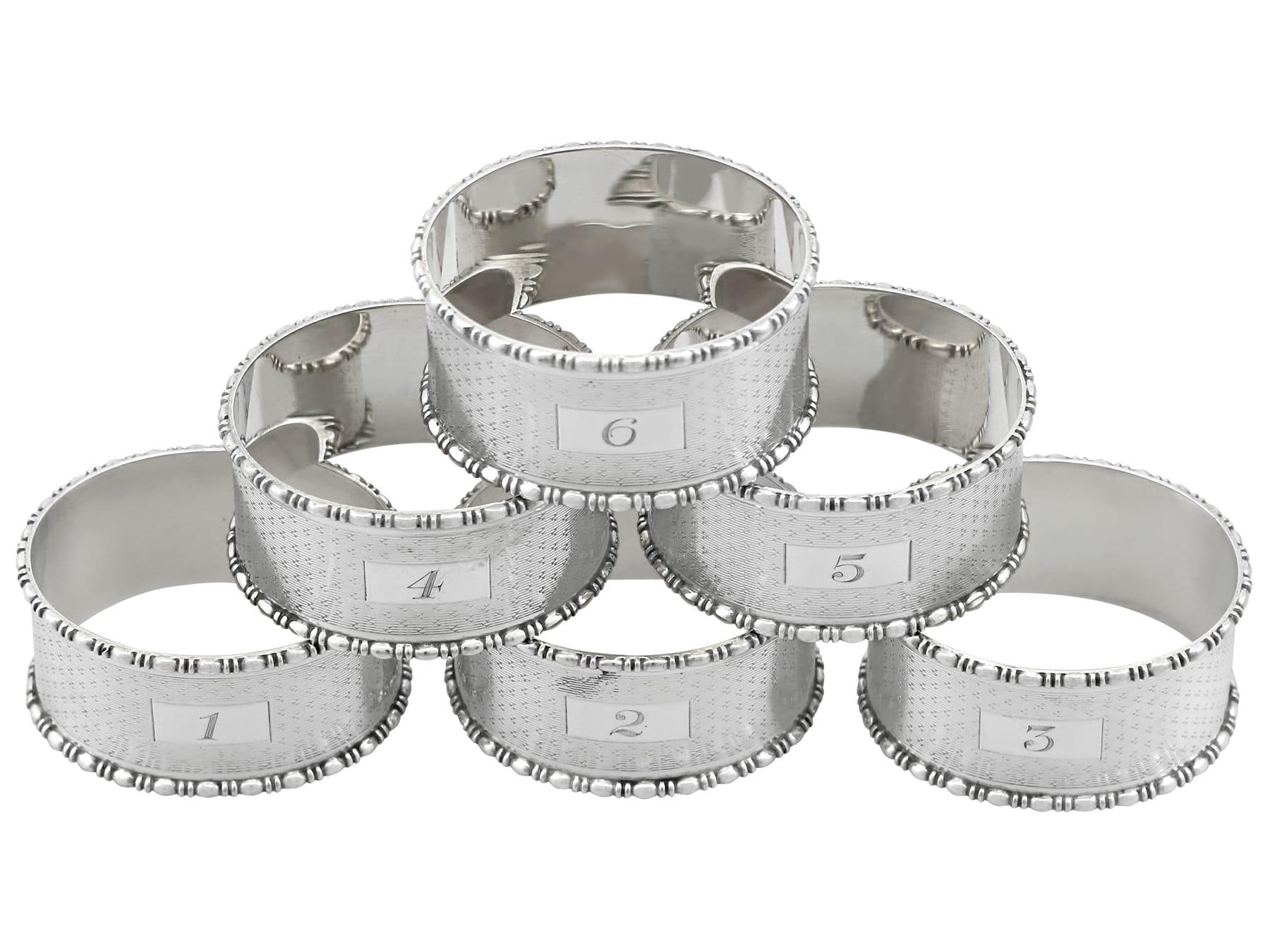 A fine and impressive set of six antique George V sterling silver numbered napkin rings; an addition to our dining silverware collection.

This fine and impressive set of antique George V silver napkin rings consists of six napkin rings, each with