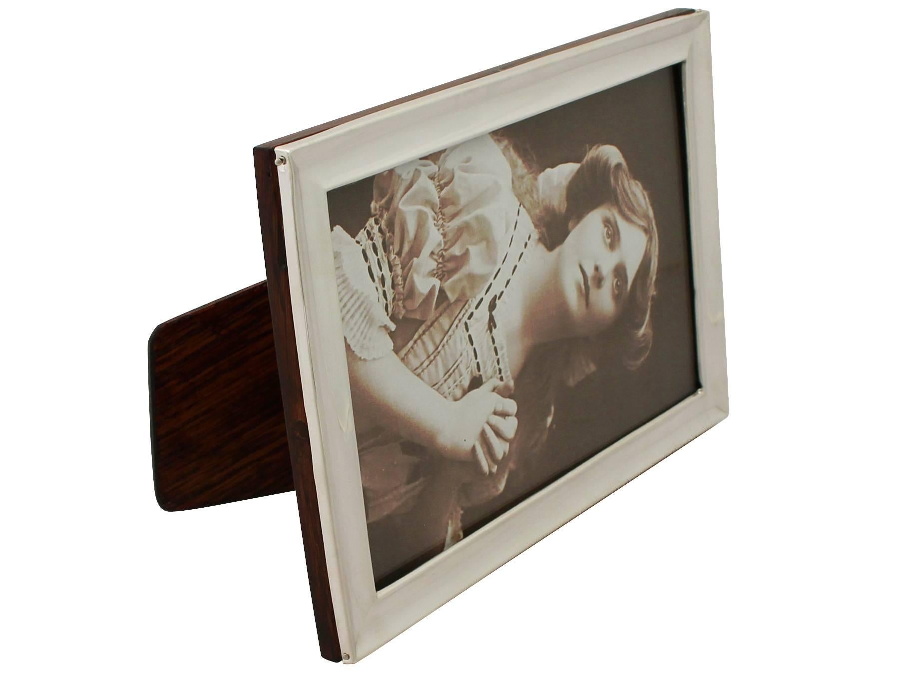 A fine and impressive antique George V English sterling silver photograph frame; an addition to our collection of ornamental silverware.

This fine antique George V sterling silver photograph frame has a plain rectangular form.

The surface of