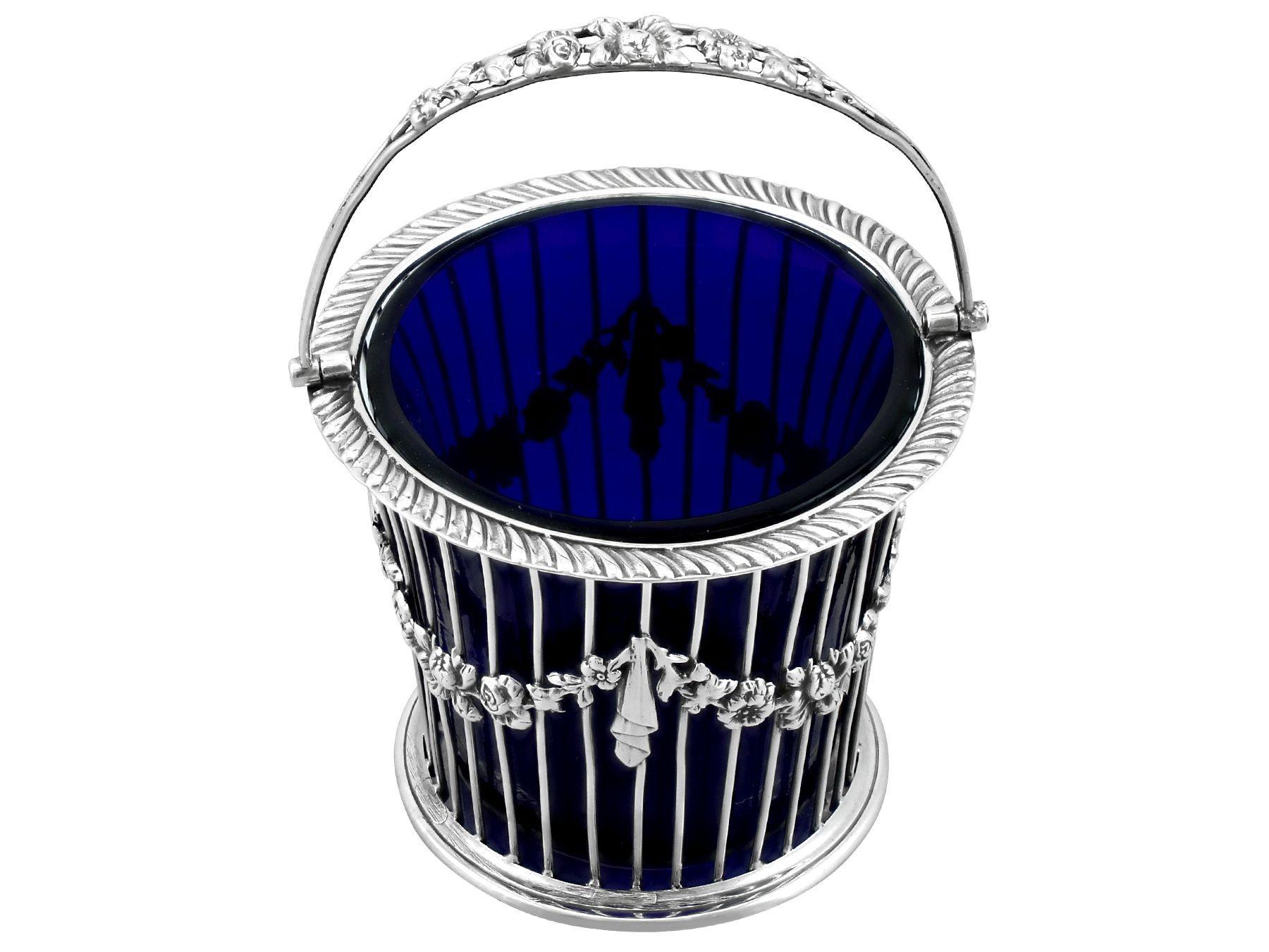 An exceptional, fine and impressive antique George V English sterling silver and blue glass sugar basket; an addition to our silver teaware collection

This exceptional antique George V sterling silver sugar basket has a tapering cylindrical form