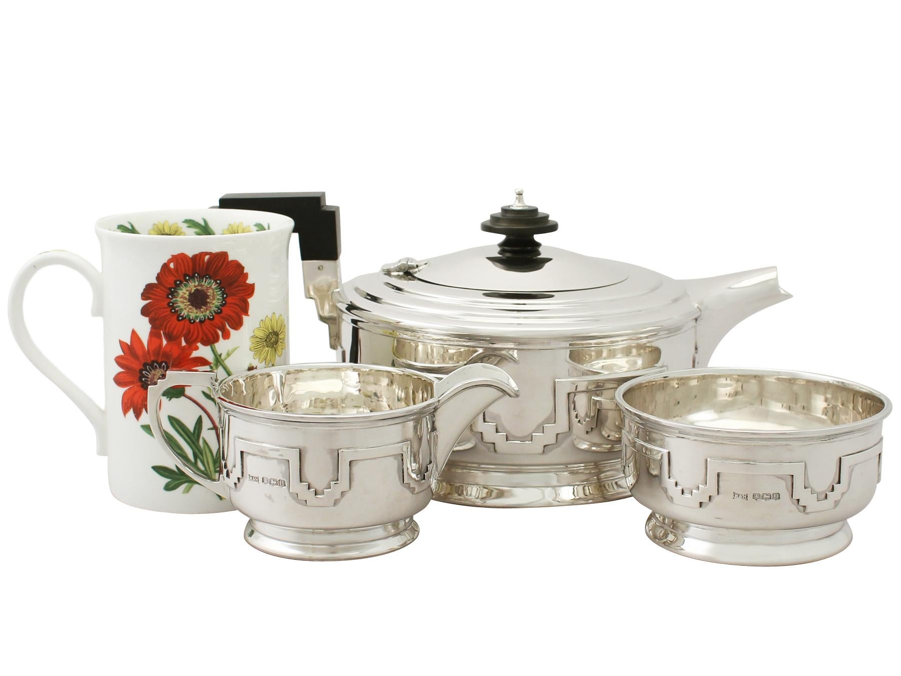 An exceptional, fine and impressive antique George VI English sterling silver three-piece tea service/set made in the Art Deco style; an addition to our silver teaware collection.

This exceptional antique George VI sterling silver three-piece