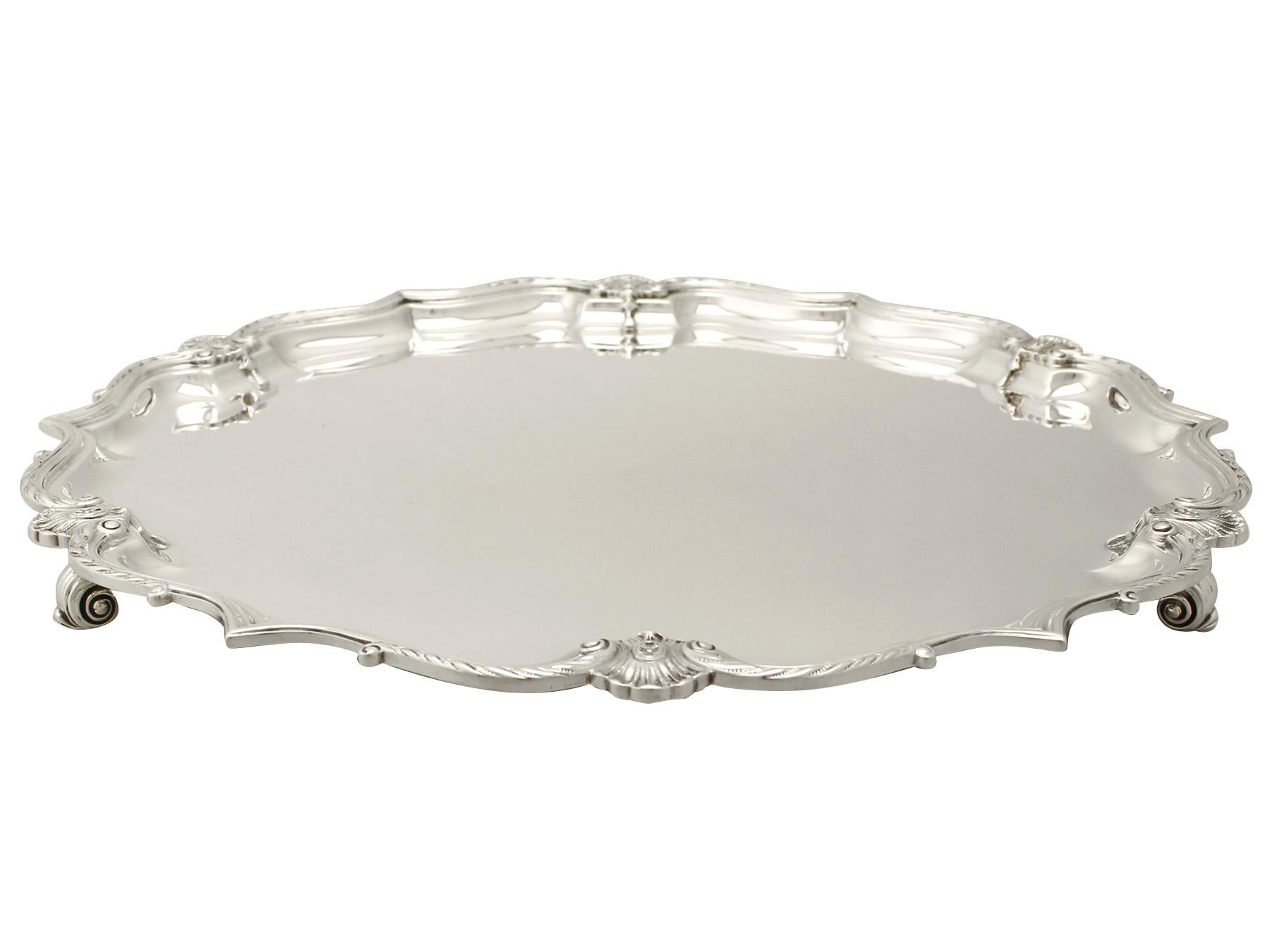 An exceptional, fine and impressive antique George VI English sterling silver salver, an addition to our silver dining collection.

This exceptional antique George VI English sterling silver salver has a circular shaped form onto three