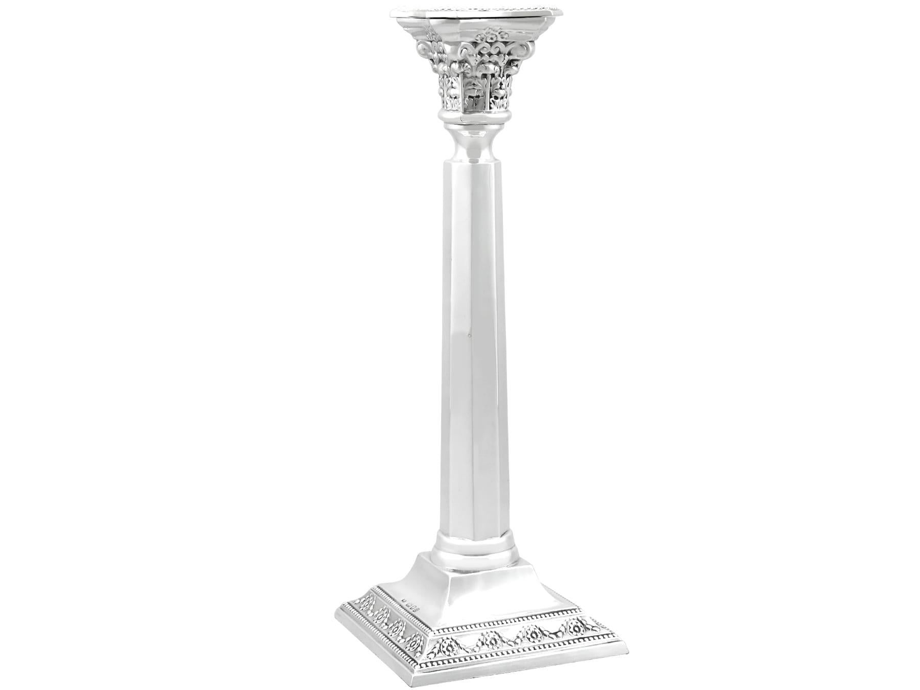 A fine and impressive, pair of antique George VI English sterling silver candlesticks; part of our ornamental silverware collection.

These impressive antique 1930s English sterling silver candlesticks have a plain subtly tapering columnar