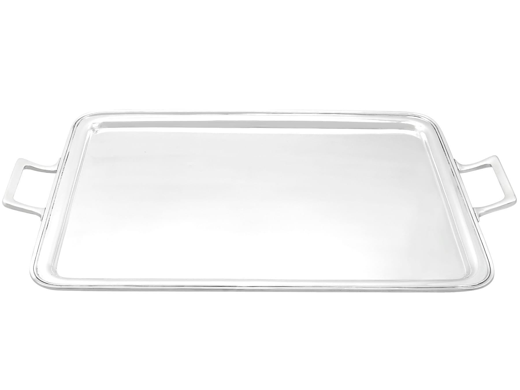 An exceptional, fine and impressive antique George VI English sterling silver two-handled tray; an addition to our silver serveware collection.

This exceptional antique George VI sterling silver tray has a rectangular form with rounded corners.
The