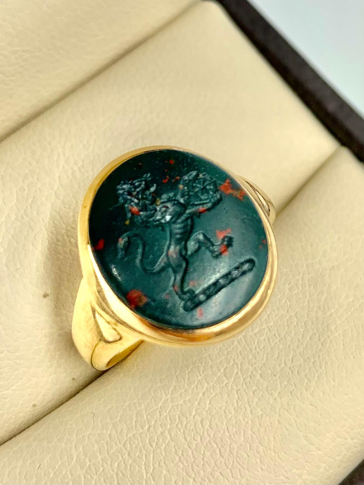 Beautiful Georgian period gold signet ring with a bloodstone intaglio crest of a lion passant holding the wheel of fortune. The bloodstone with lovely old patina and great detail, curved on the back for a wonderful fit on the finger. The lion is the