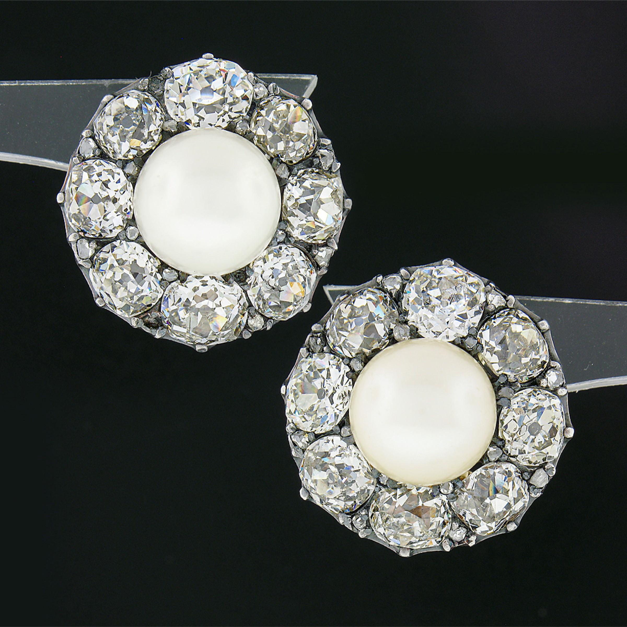 This gorgeous and fancy pair of antique cocktail earrings was crafted in solid 14k yellow gold with a solid silver top during the Georgian period. Both earrings feature a, GIA certified, natural saltwater pearl solitaire which is surrounded by a