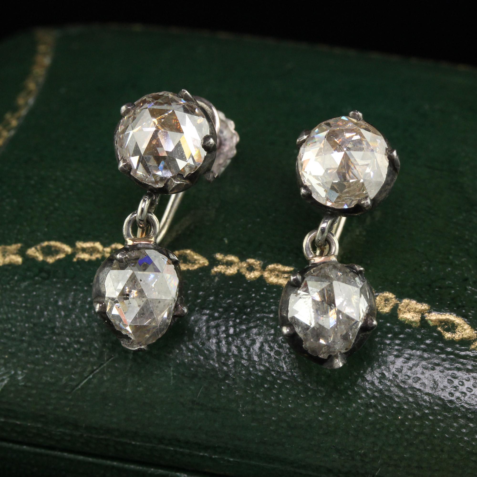 Beautiful Antique Georgian 14K White Gold Silver Rose Cut Diamond Drop Dangling Earrings. This gorgeous pair of Georgian diamond earrings are crafted in silver and 14k white gold. These drop earrings have chunky old rose cut diamonds on top and