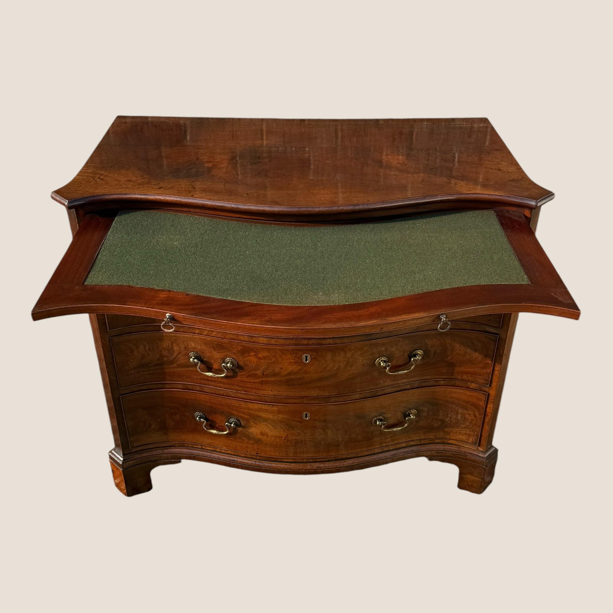 Here we have a superb quality Antique Georgian, Circa 1760, Mahogany Serpentine Chest of Drawers with Writing Brush & Slide.

This chest comprises of 4 graduated drawers each with ornate detailed swan neck brass handles & key inscriptions between