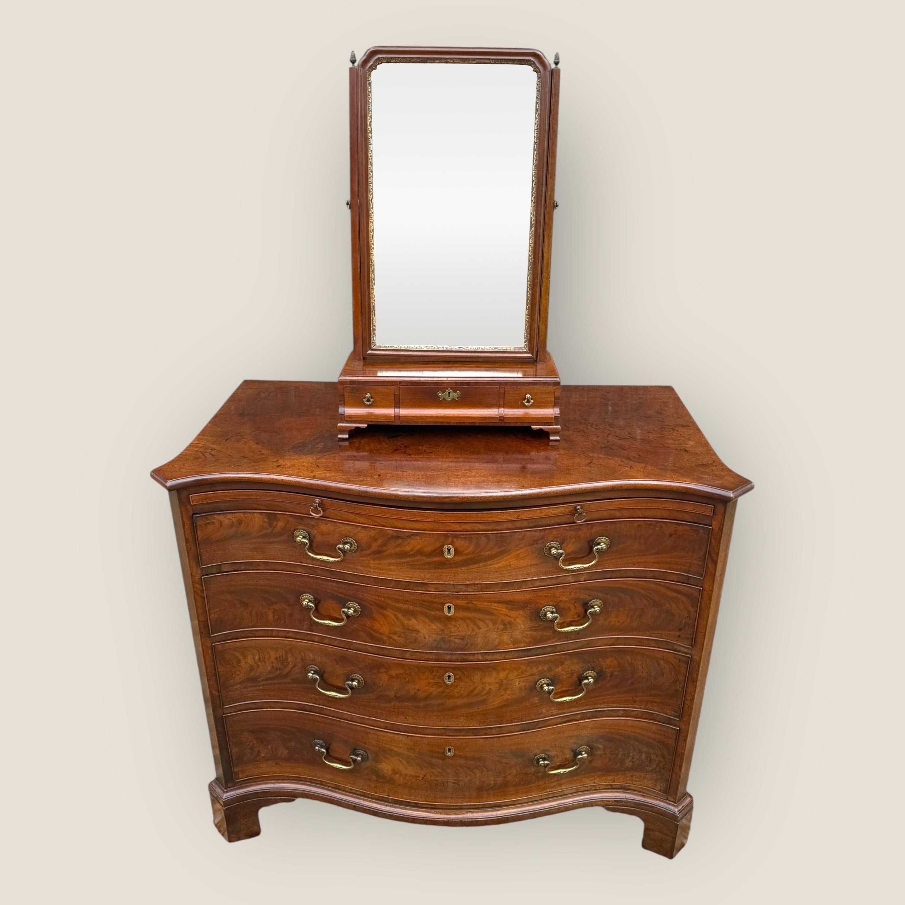 Here we have a Georgian mahogany dressing table mirror standing on ogee bracket feet with three drawers and brass acorns on top of each post.