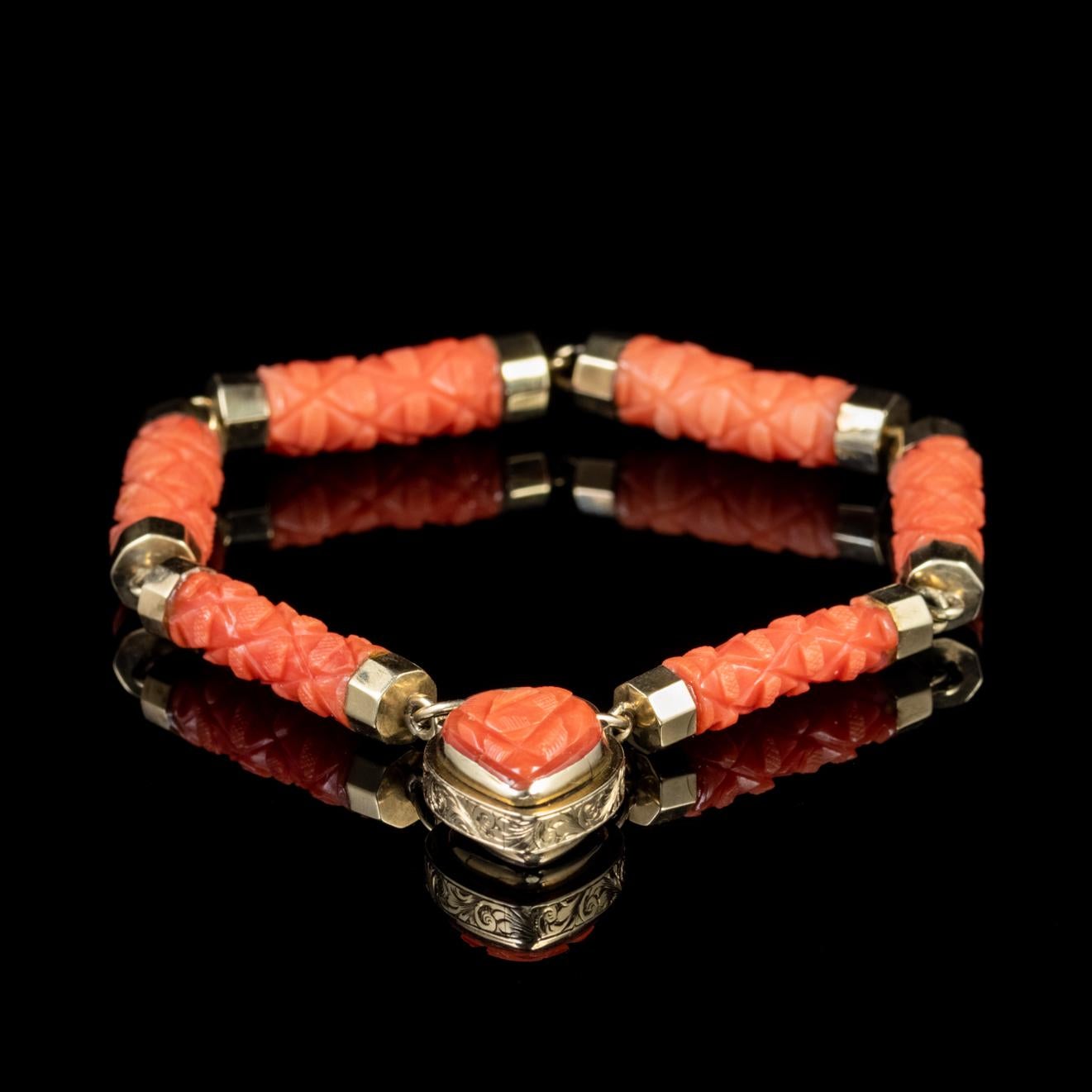 A beautiful antique Georgian bracelet made up of fancy engraved Coral links with 18ct Yellow Gold tips.  

Similar to Pearls, Coral is made naturally in the depths of the ocean and boasts fiery shades of petal pink and burnt orange which were