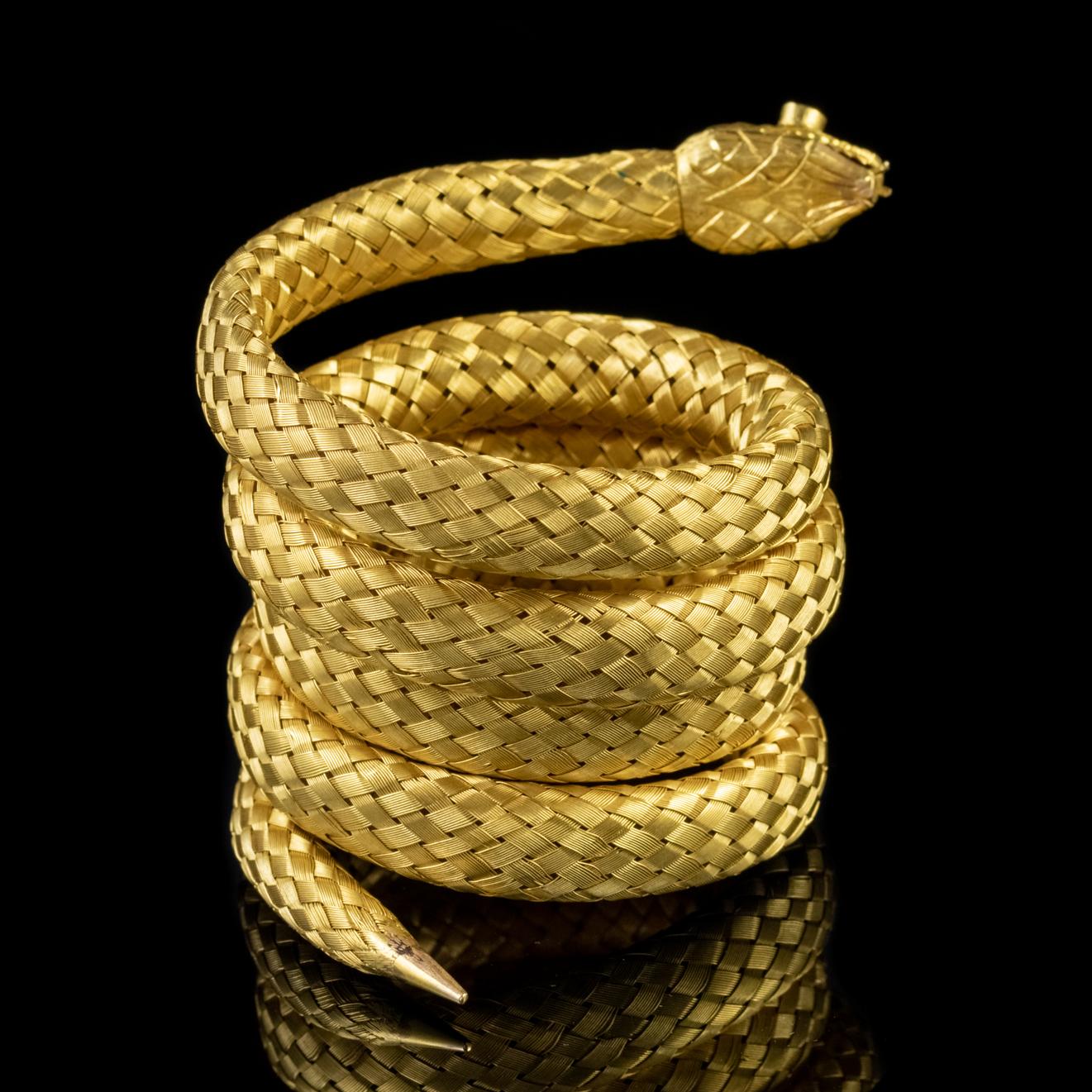 This fabulous antique Georgian coiled snake bracelet has been exquisitely crafted in 18ct Yellow Gold. Multiple strands of woven gold have been cunningly laced together to create a flexible body with scales running along its length.

The piece is