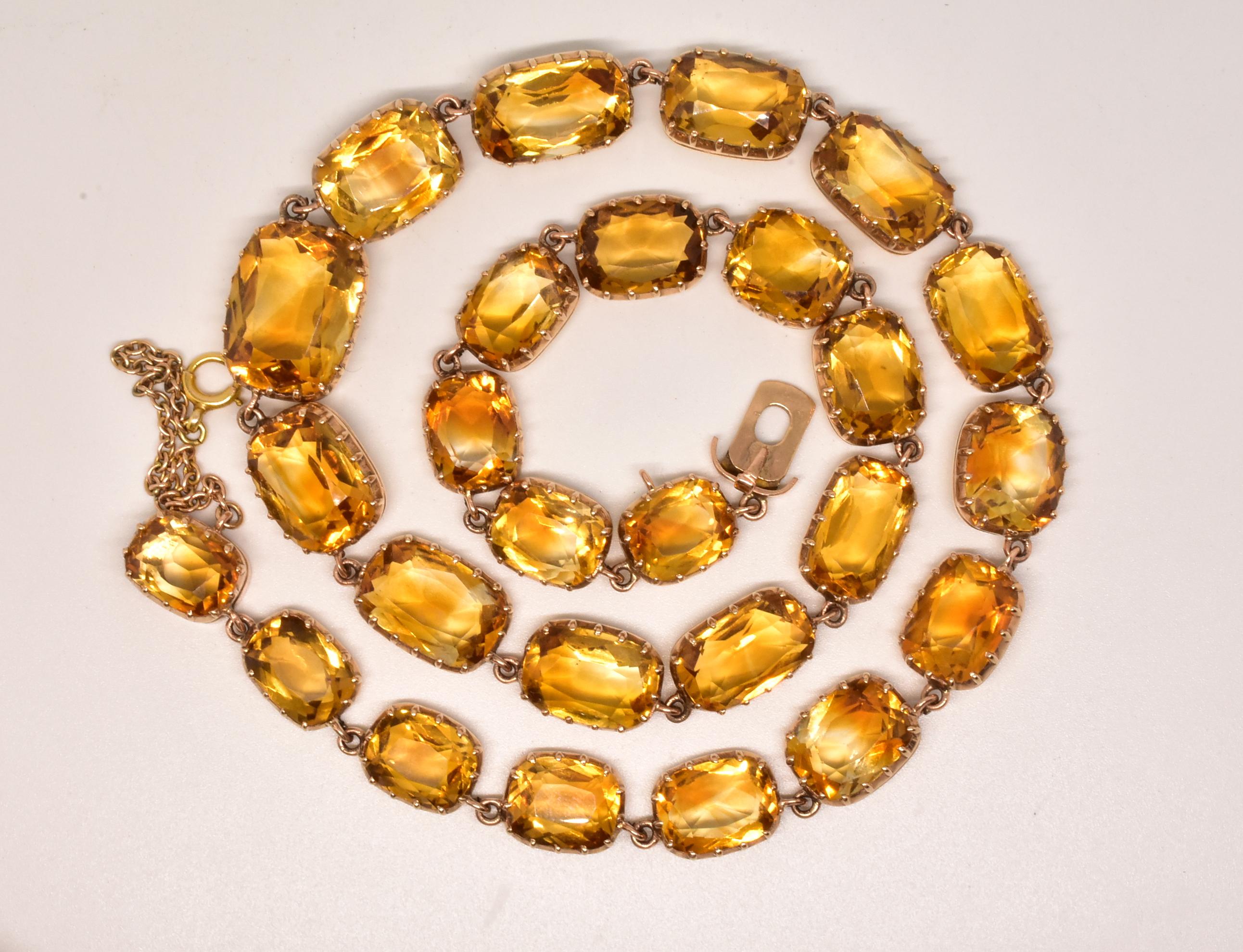 This stunning demi-parure  includes an 18K faceted citrine necklace and matching pair of pendent earrings. Such necklaces were called rivieres (