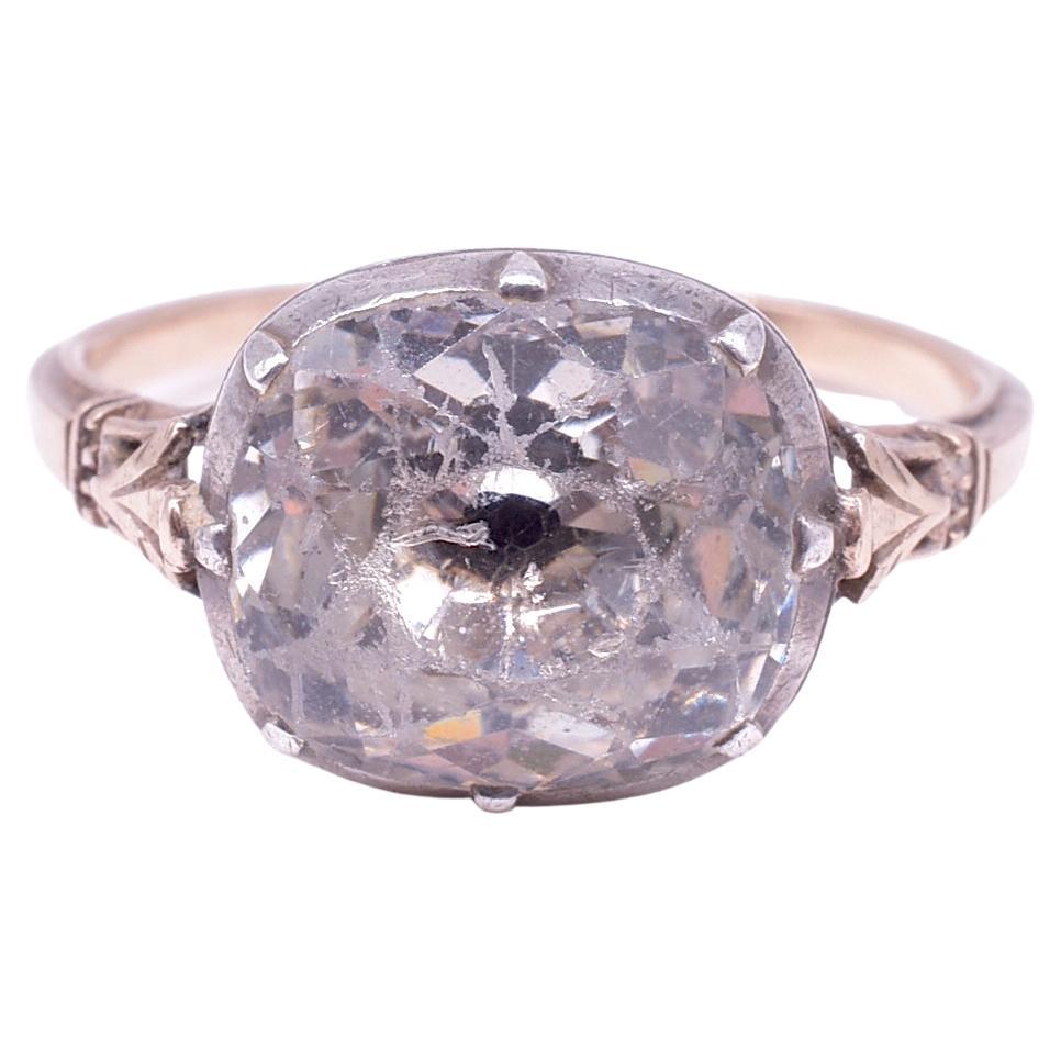 Dramatic English Georgian period paste single stone cushion cut ring set in silver and backed in 18K. The ring is nicely engraved at the shoulders with an 18K band.  The carved paste is set in silver basket setting.  The ring has trifurcated