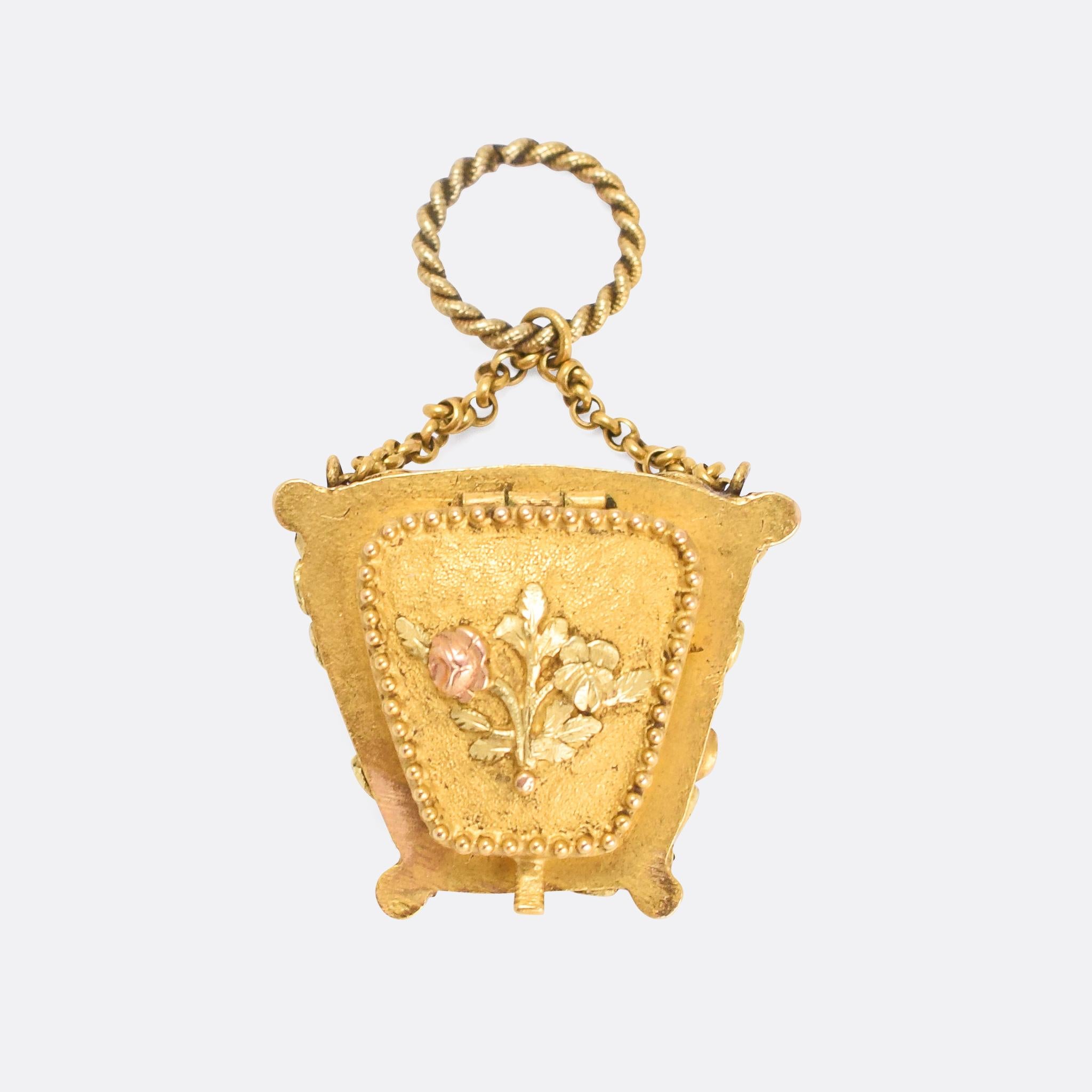 An astonishing Georgian acrostic locket modelled as a purse. The front has the most wonderful applied flowers, in three-tone gold, and is set with stones to spell out the word SOUVENIR - which in this case, translating directly from the French,