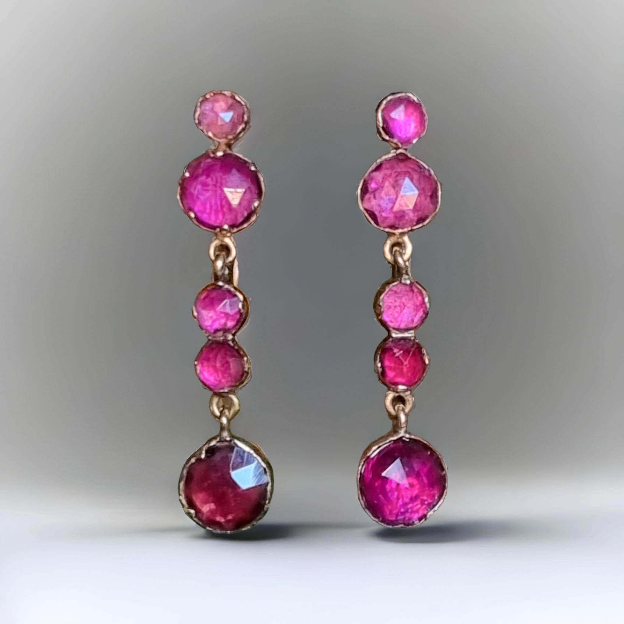 Antique Georgian Almandine Garnet Drop Earrings (1810-1820)
A pair of 14K gold graduated rose cut garnet drop earrings. Each earring  has five garnets set in pinched collet settings that have been foiled to give luminescence to the stones at the