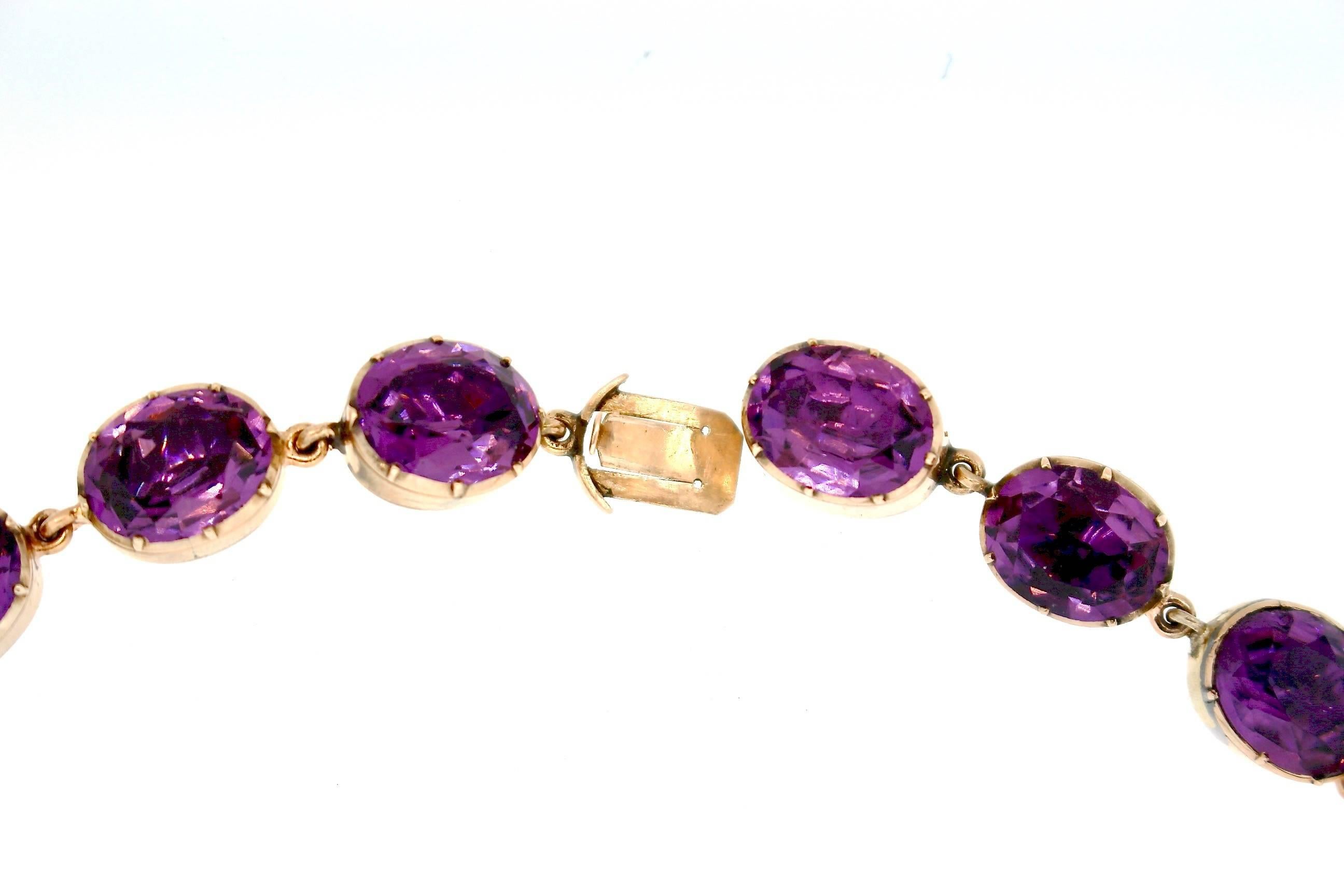 A bright and lively amethyst gold riviere necklace from about 1830.  This necklace is made up of brilliant colored amethysts, likely Russian in origin.  These necklaces from the Georgian era were popular and sought after.  Often they were part of