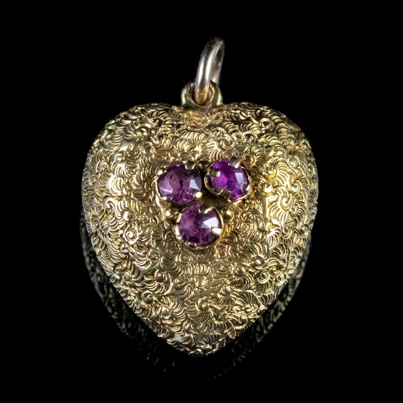 A beautiful Antique Georgian pendant in the shape of a heart, which is modelled in 18ct Yellow Gold. It features approx. 0.15ct of Amethysts on the front, a stunning 3ct Amethyst on the back and is fully engraved with fine detailing.

Amethyst has
