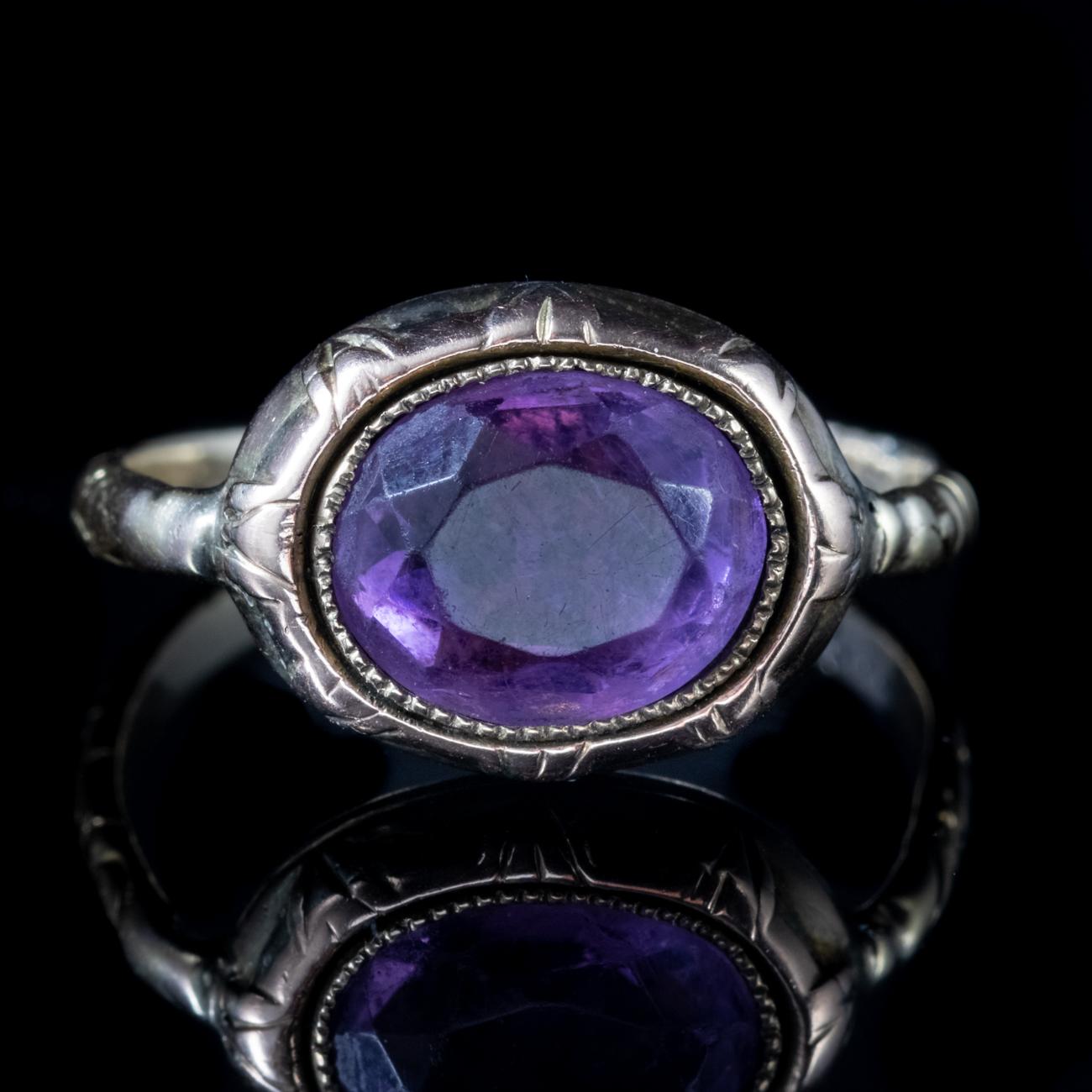 This stunning Antique Georgian ring, known as a Bishop’s Ring, is modelled in 18ct Yellow Gold and features a beautiful central Amethyst weighing 3ct. Both the gallery and the shank also feature beautiful engraving all around.

A Bishop’s Ring is a