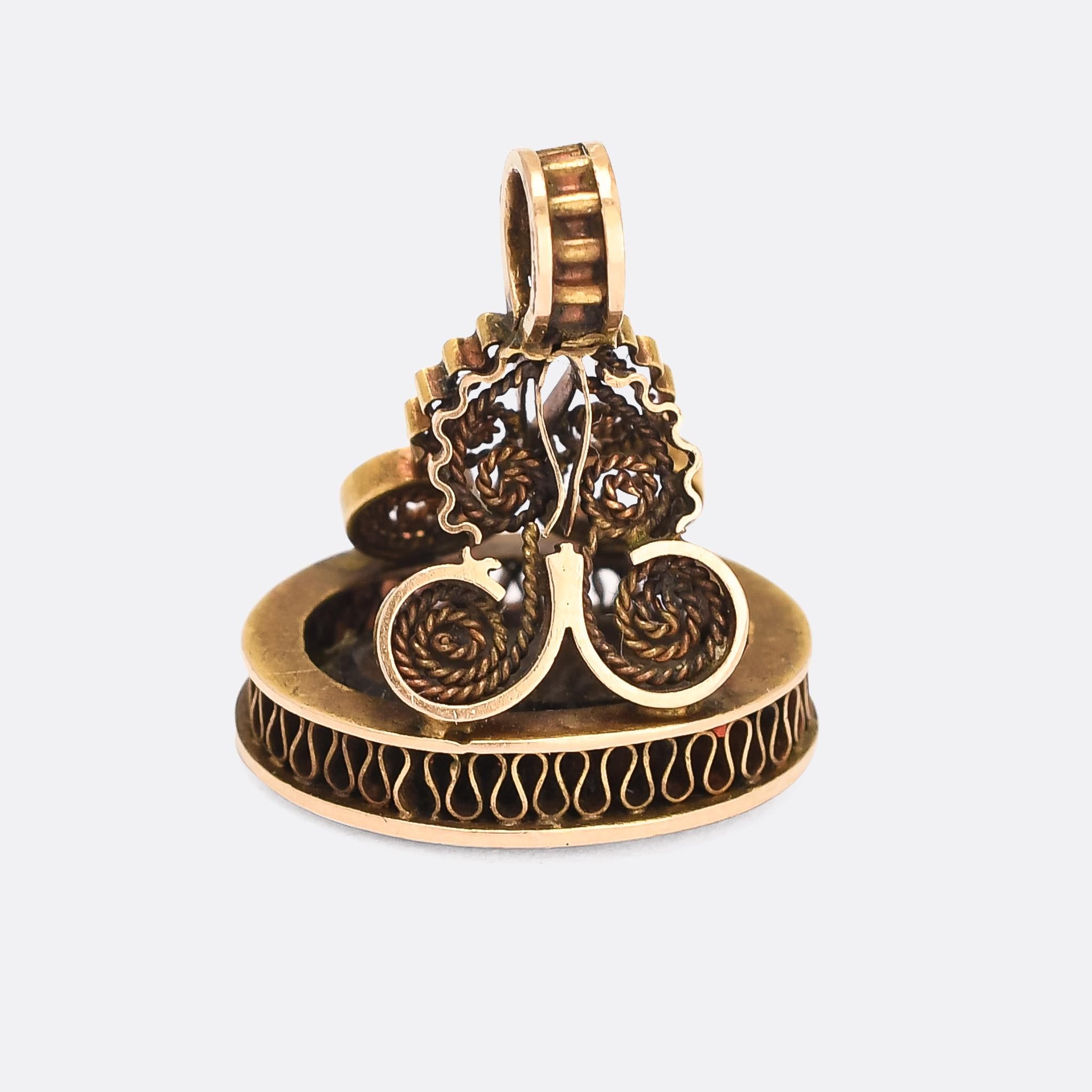 A gorgeous Georgian seal fob dating from the 1830s. It's set with an agate seal in the base, carved with the word Amitié (friendship). The fob itself is a masterclass in openwork, featuring wire and ropework and modelled in 15 karat gold