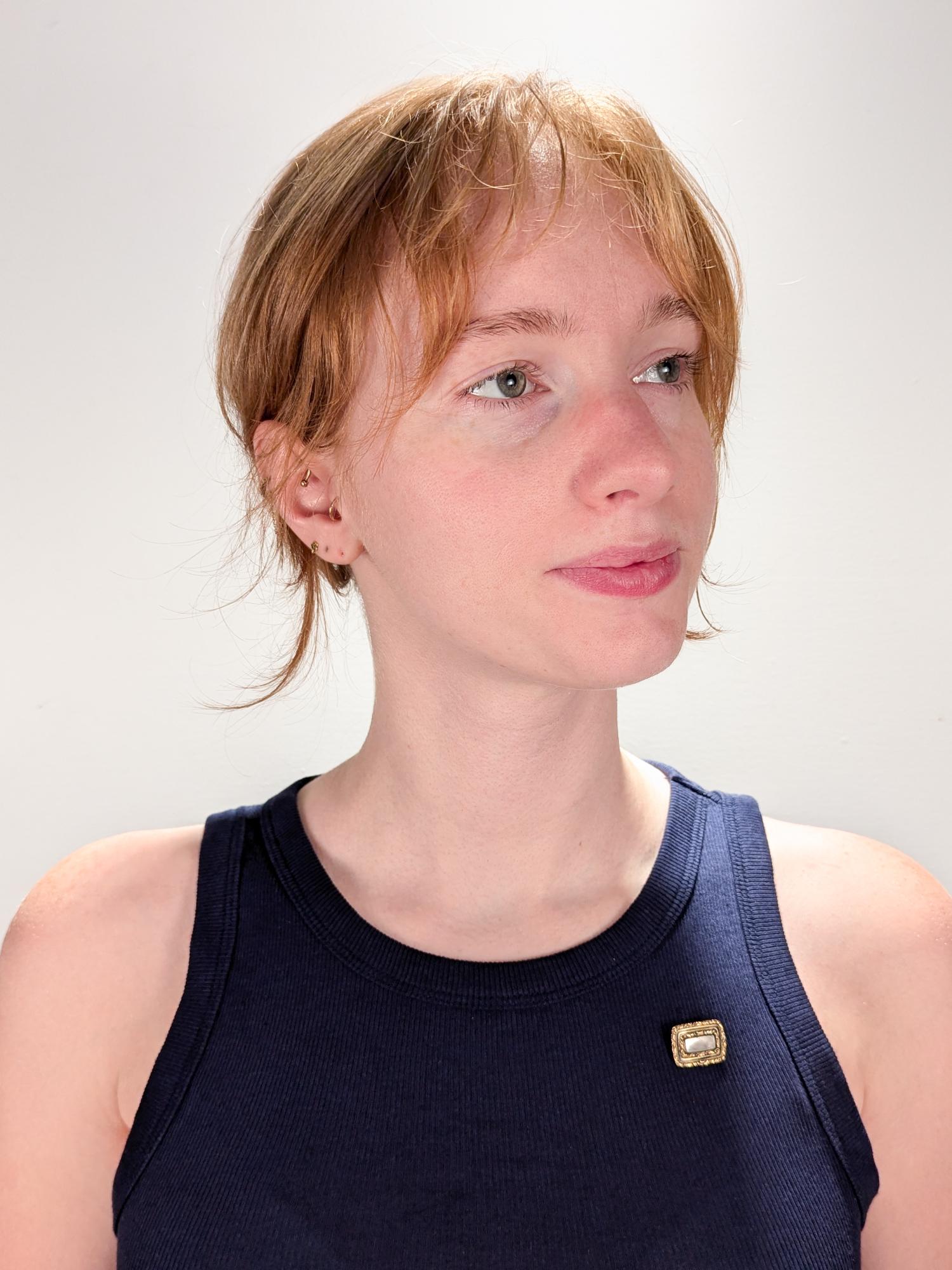 A fine Georgian gold and enamel hair art mourning pin.  

With blonde braided hair set behind glass in a worked gold and black enamel setting.

The dedication on the reverse reads: 