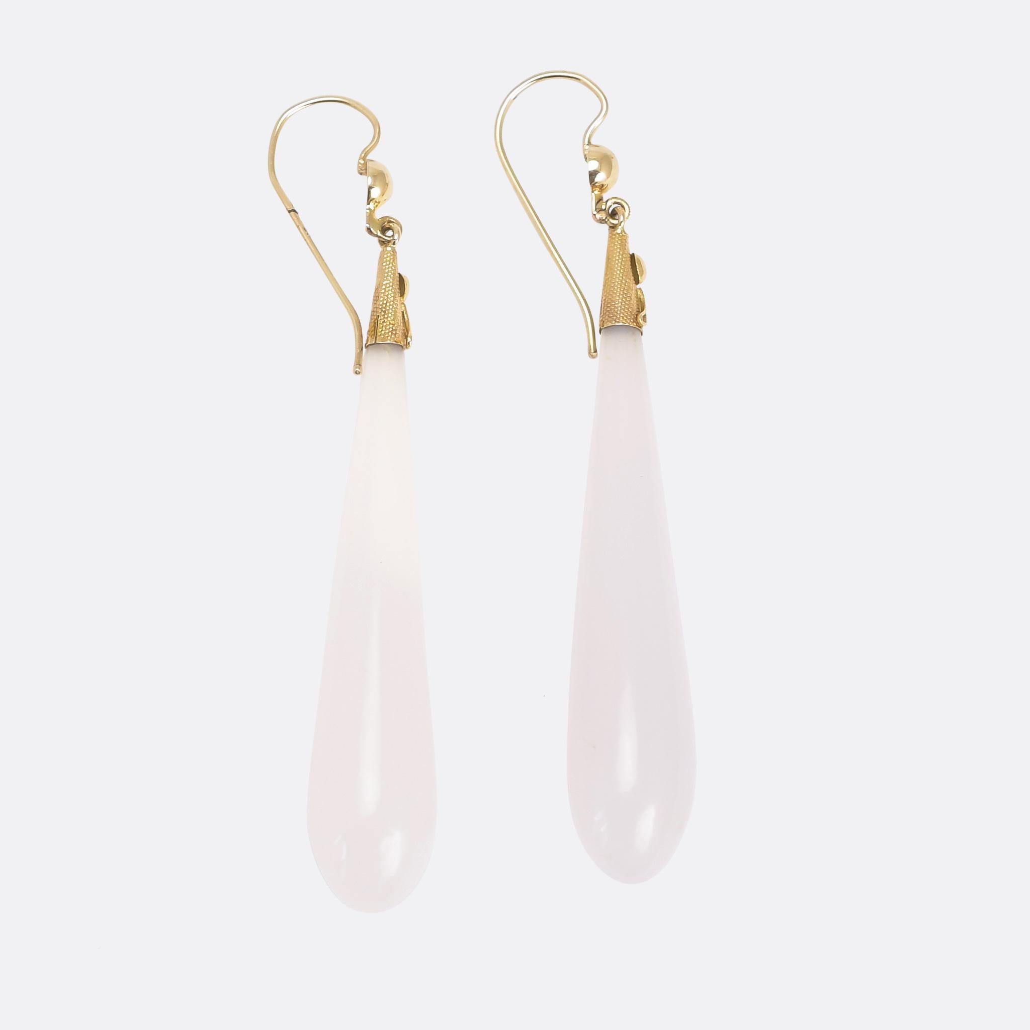 The most beautiful Georgian chalcedony teardrop earrings dating from the 1830s. The tops are textured 15 karat gold, with applied gold ornamentation, and the stones are a gorgeous pale milky blue colour. With a 6cm drop they're a great length, and