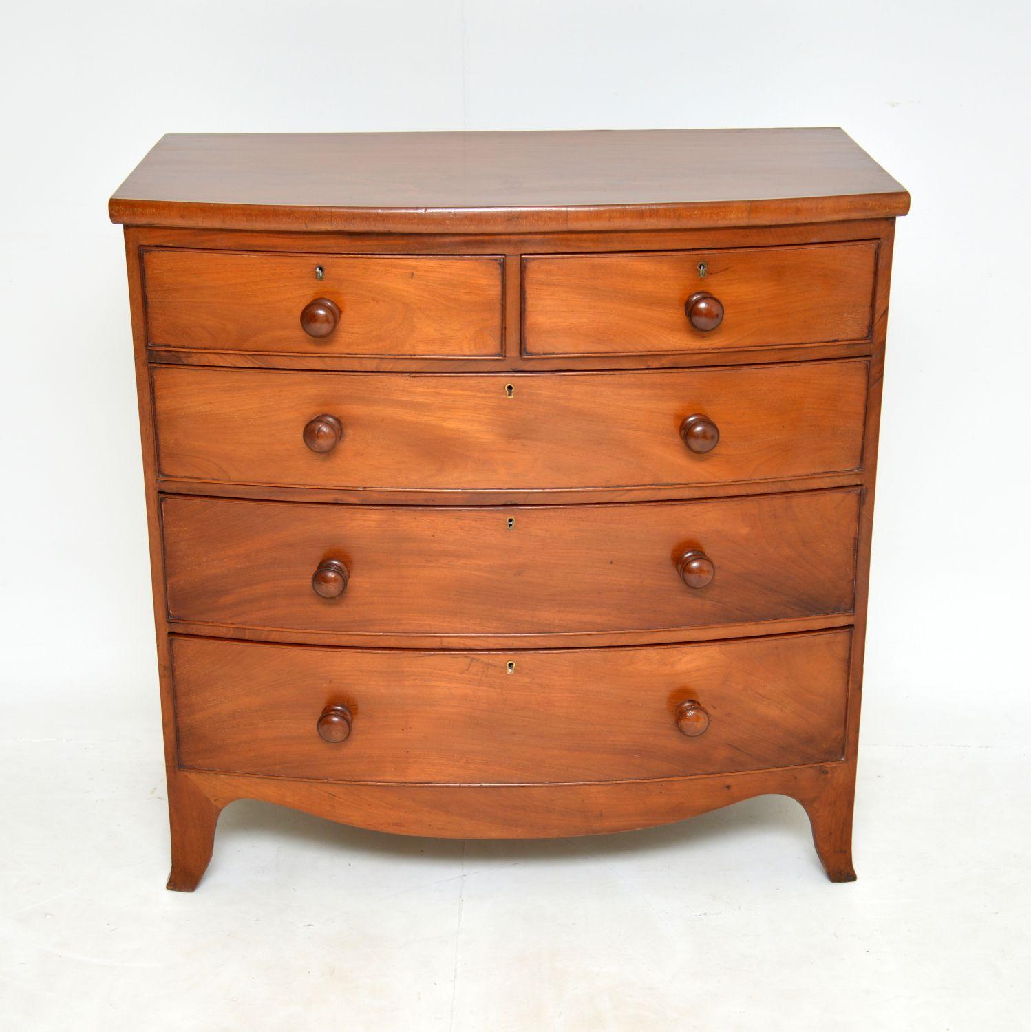 A smart and useful large bow front Georgian chest of drawers. This was made in England, it dates from around the 1810-1830 period.
This is very well made and is a great size, with lots of storage space. It has lovely turned solid wood handles and