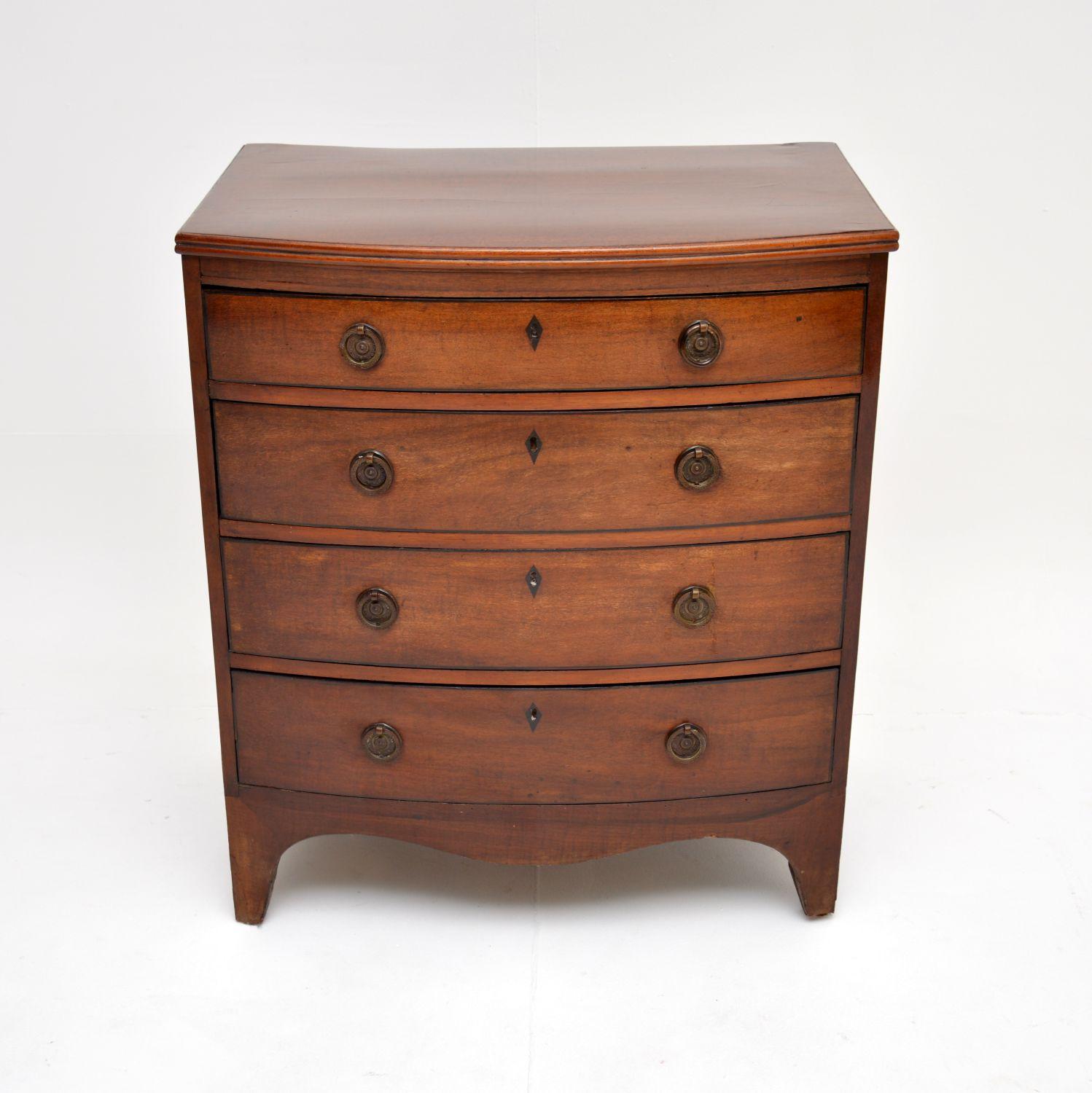 A very small and fine quality antique Georgian period bow front chest of drawers. This was made in England, it dates from around the 1790-1810 period.

It is very well made and has lovely, very useful proportions. The wood has a gorgeous colour tone