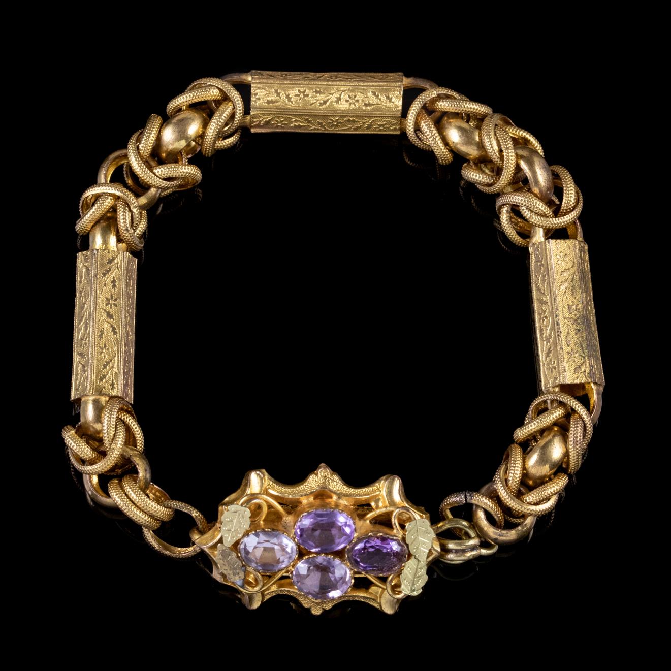 An exquisite antique Georgian bracelet featuring an ornate box clasp decorated with four natural Amethysts, approx. 1.25ct in total among a bed of Golden leaves. 

The bracelet is made up of intertwined pinchbeck links gilded in 18ct Yellow Gold