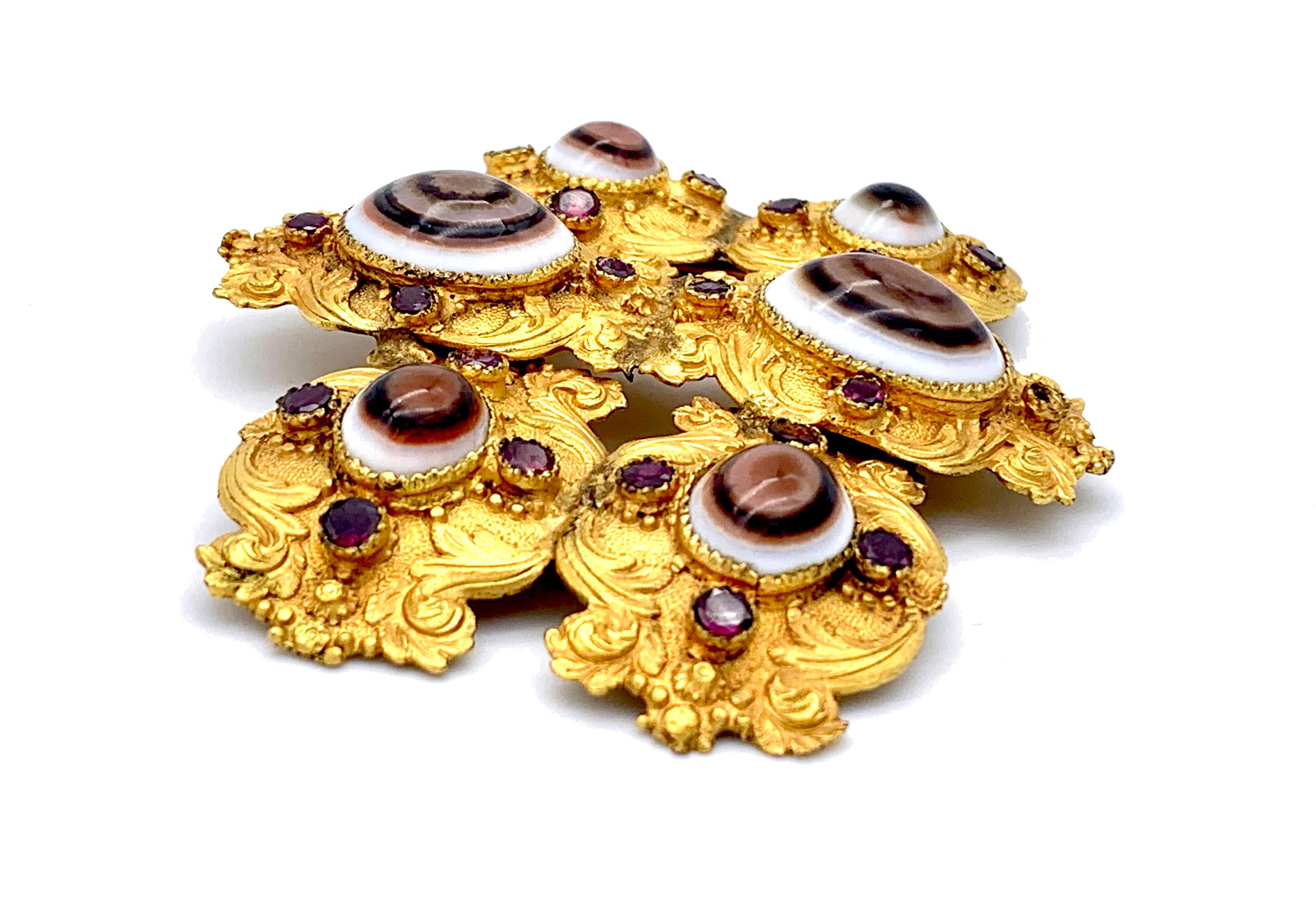d This outstanding dress buckle uses the combination of flat cut garnets and banded agates chosen for their eye resemblance. Agates cut this way have been used in jewellery since antiquity all around the word. They were given the power to ward off