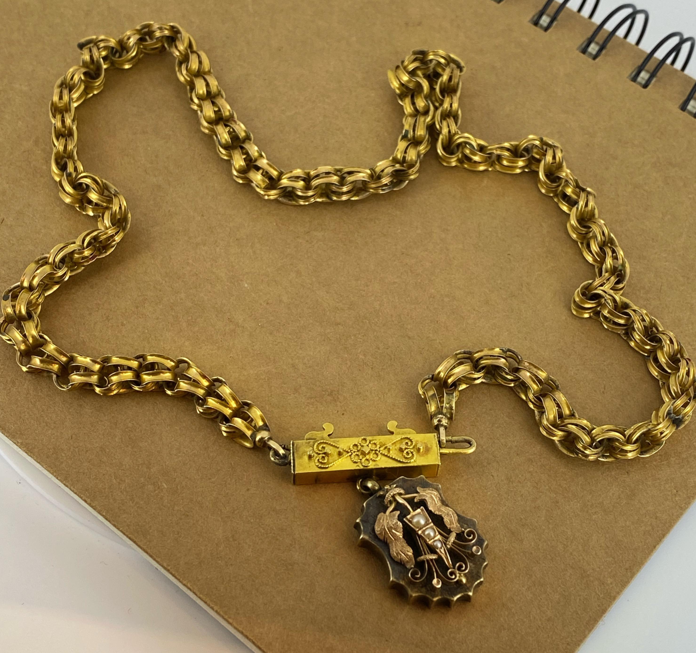 This antique Georgian necklace is a true treasure & a rare find...

Crafted in 15K yellow gold, 
it features a shield-shaped locket pendant, 
designed as a shield, 
intricately decorated with leaves (in rose gold), scrolls & 
adorned with 3 seed