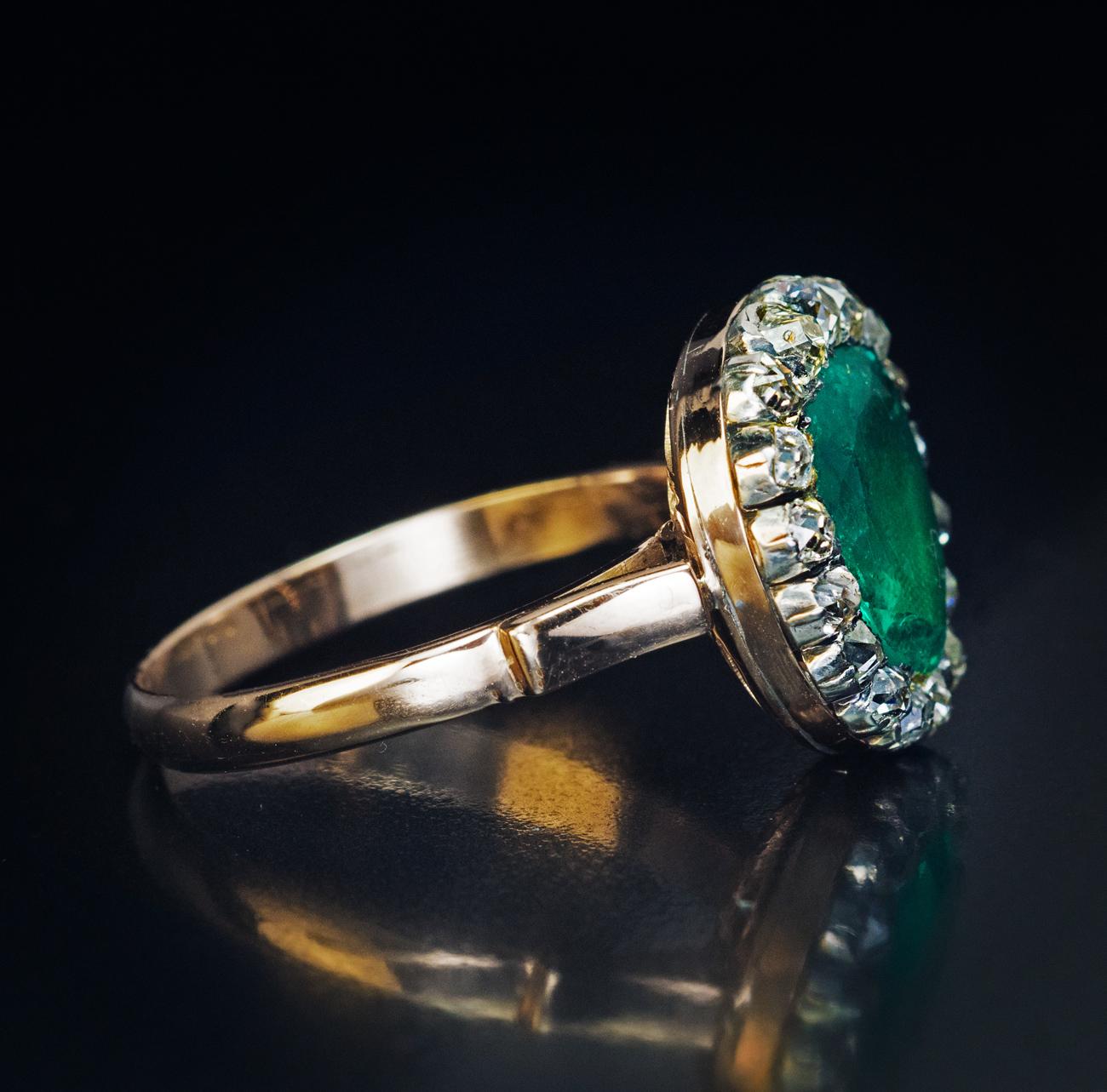 This antique heart-shaped ring from the late 1700s – early 1800s features a natural emerald of an excellent color, clarity, and saturation. The emerald is set in a closed back setting (typical for Georgian era rings) with a fabric insert behind the