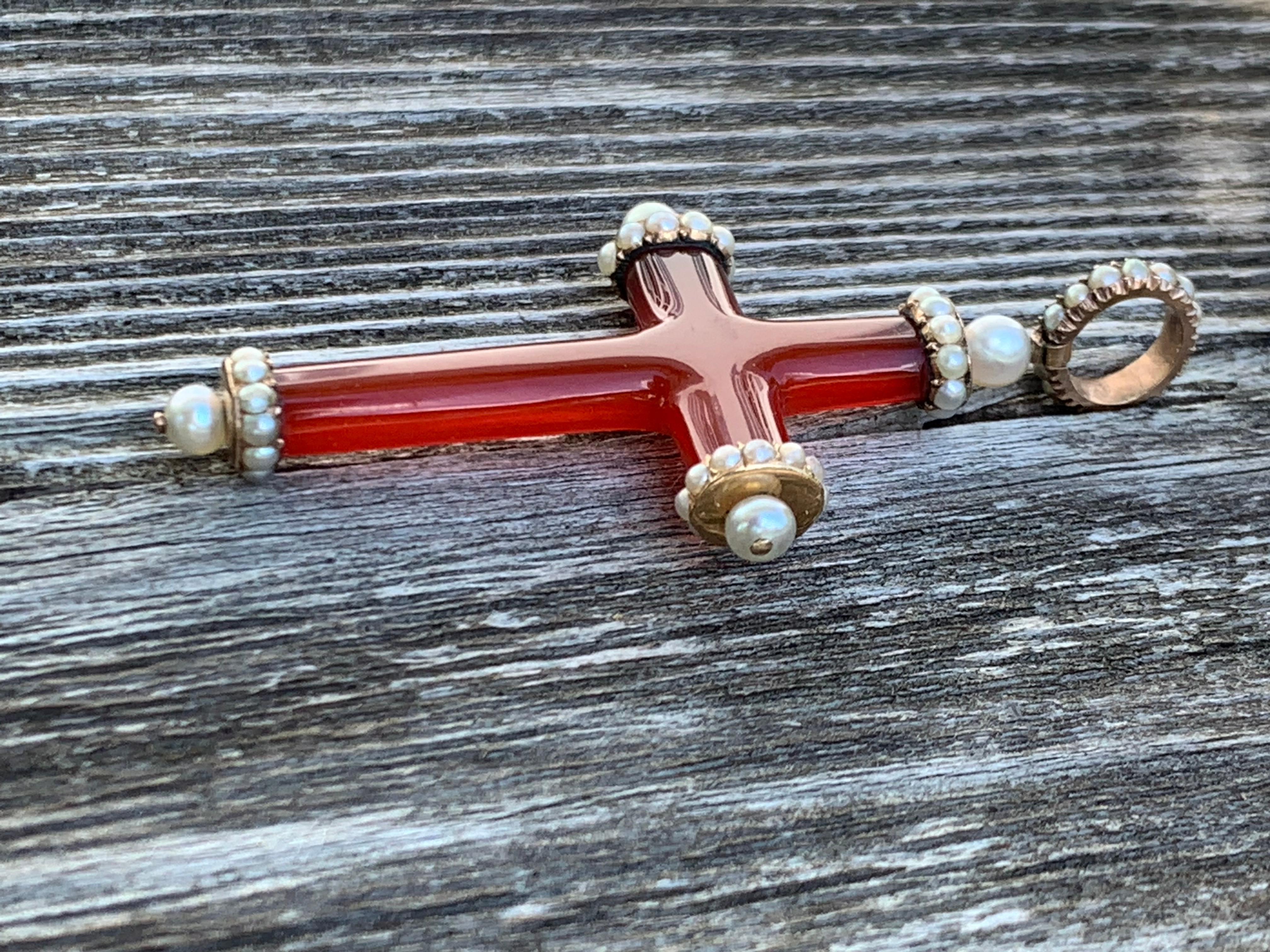 This is a truely magnificent georgian cornelian and oriental pearl cross. It is so well made that it can be worn from both sides. 