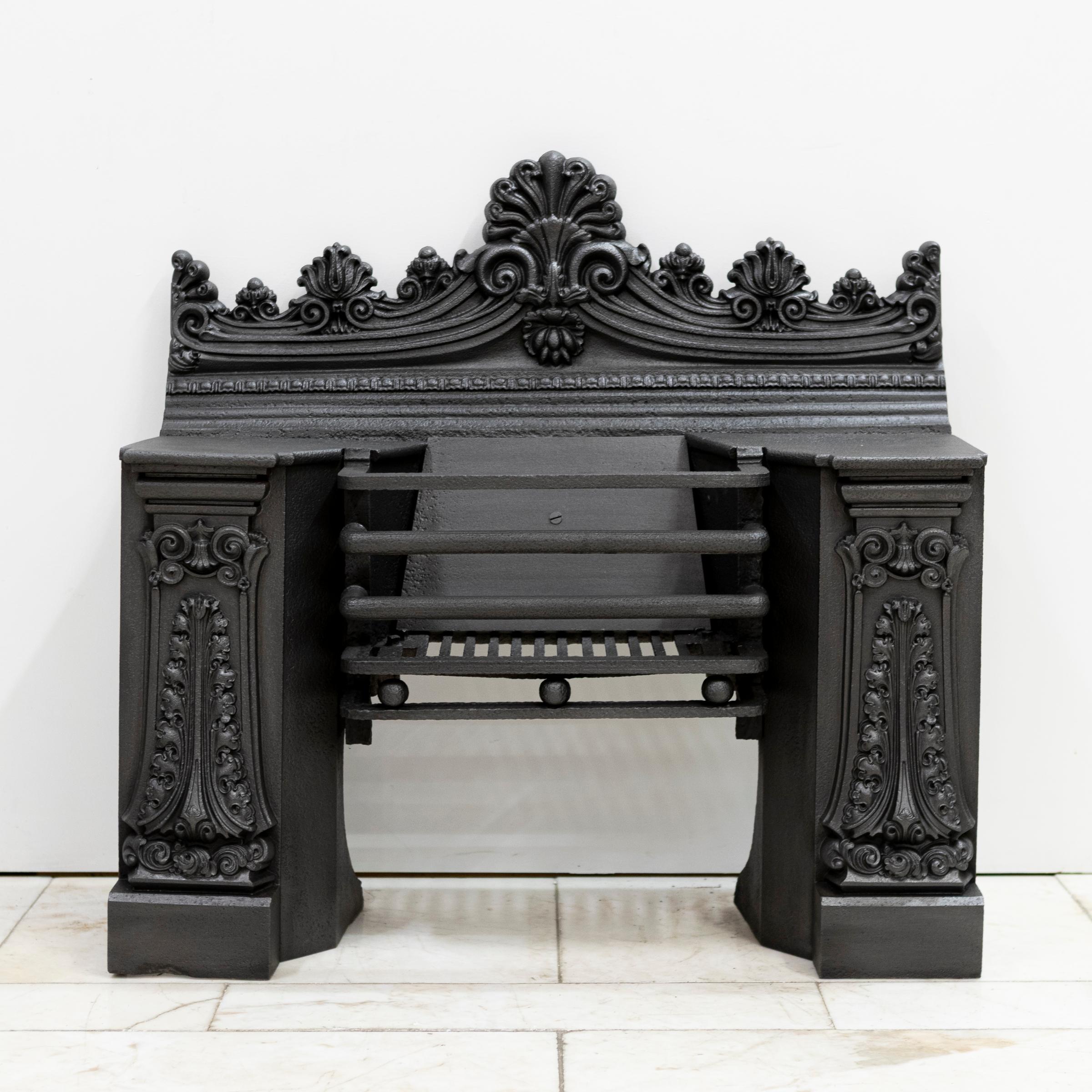 Antique Georgian Cast Iron Hob Grate of substantial stature making the piece extremely rare.
A finely cast Georgian hob grate with ornate neoclassical detailing, including scrollwork, foliate panels, and a prominent cresting. A very handsome and