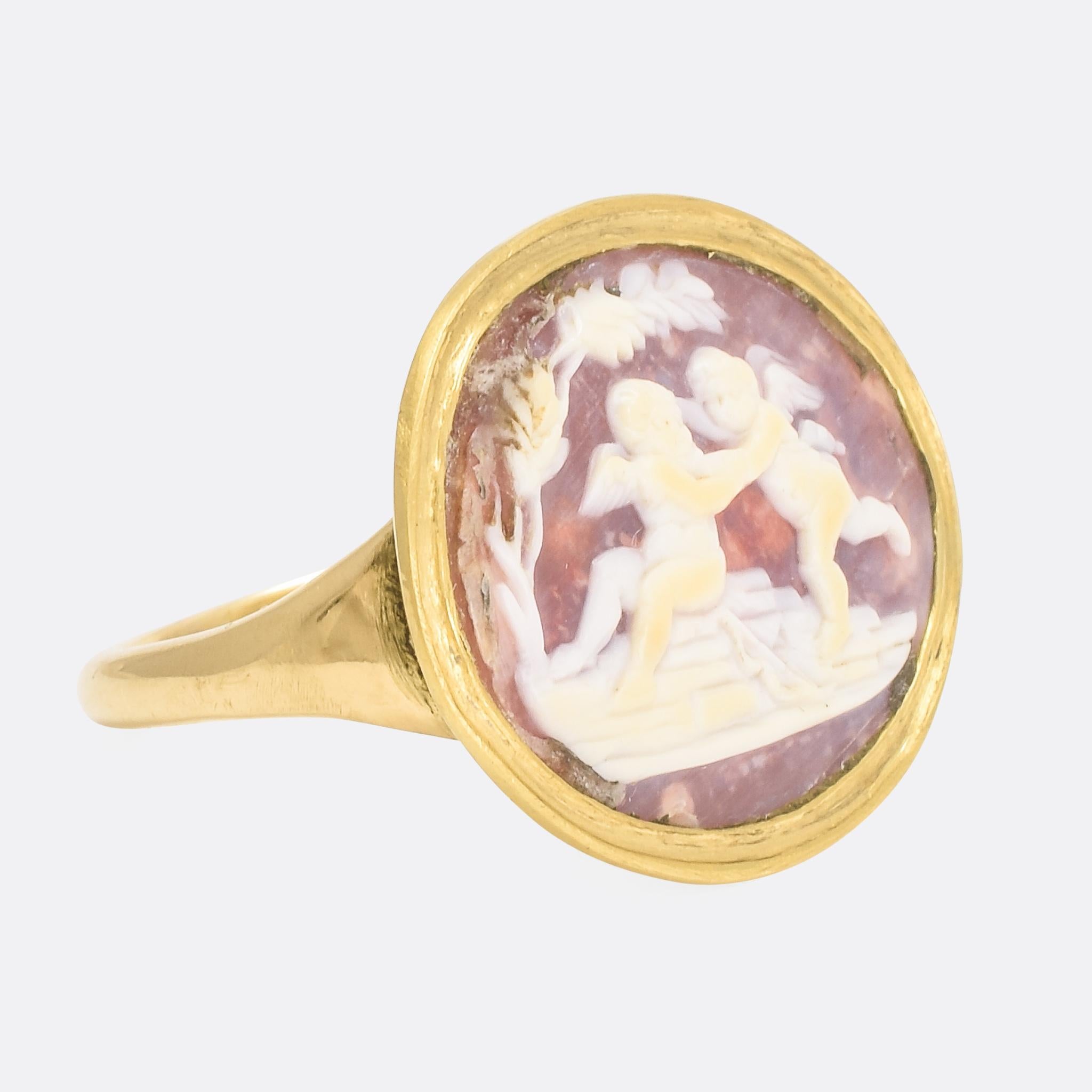 A fine Georgian cameo ring depicting two winged cherubs frolicking on a rock. The shell cameo is masterfully executed; it will have been carved in Italy, with great detail and perfect contrast between the subject and background. The ring itself was