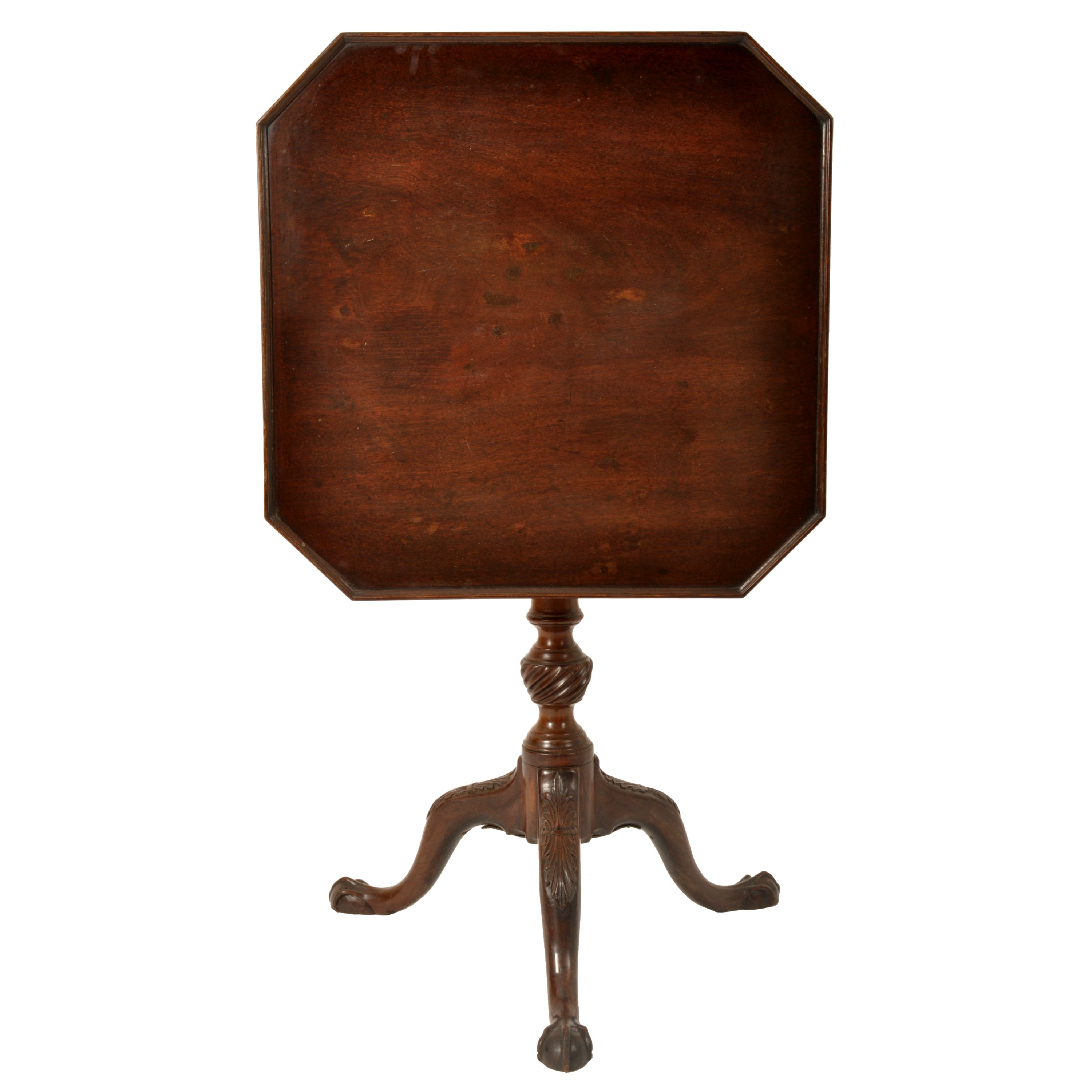 A good antique 18th century carved Chippendale George III tilt-top wine/side table, circa 1790.
The table having an octagonal top with a raised tray top, the tilt-top locks onto a bird-cage armature, allowing the top to spin around. The table stands