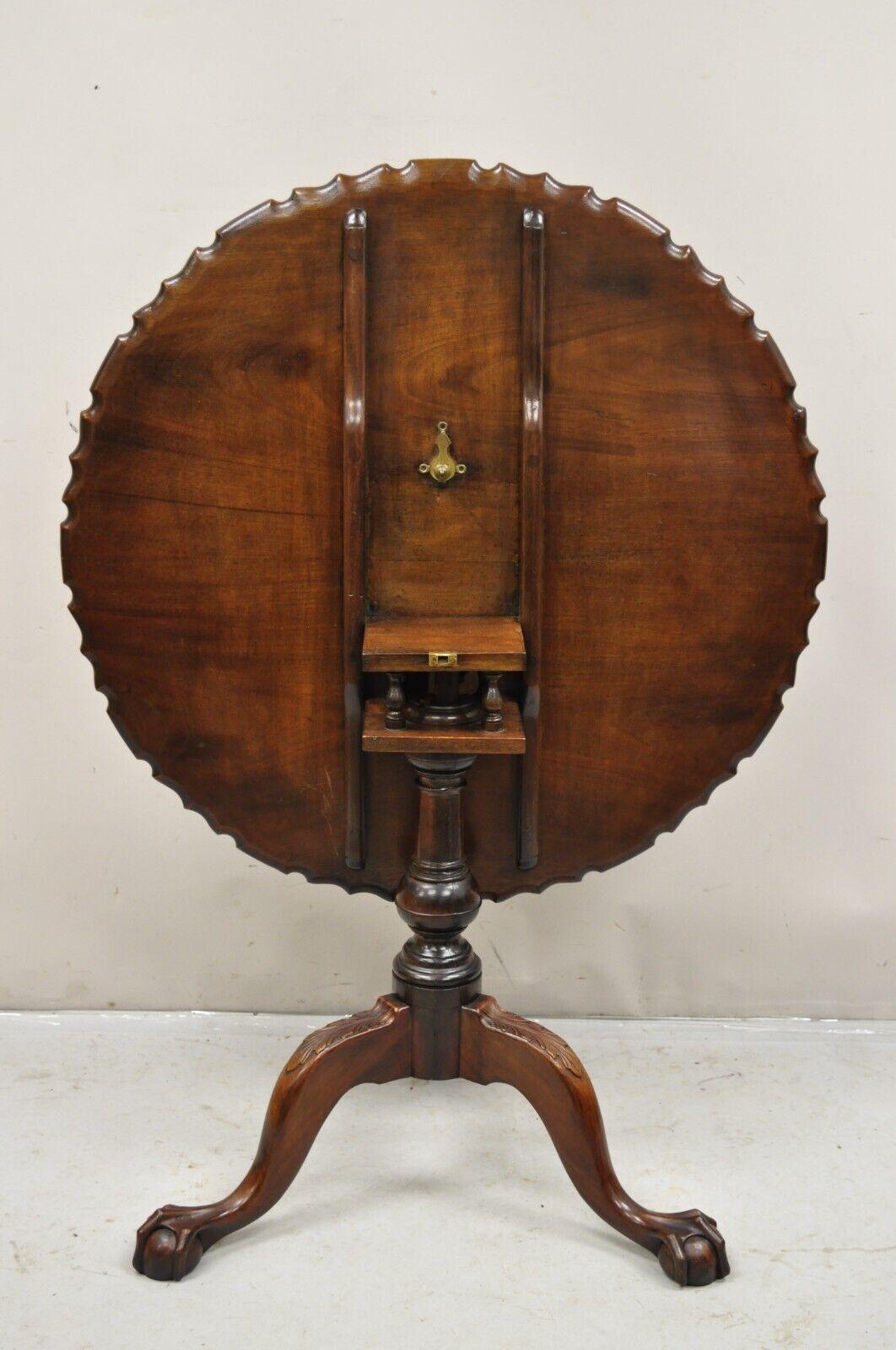 Antique Georgian Chippendale Pie Crust Mahogany Ball and Claw Tilt Top Table. Item features bird cage pedestal base, carved pie crust tilt top, acanthus leaf carved knees, very nice antique item. Circa 19th Century. Measurements: 19