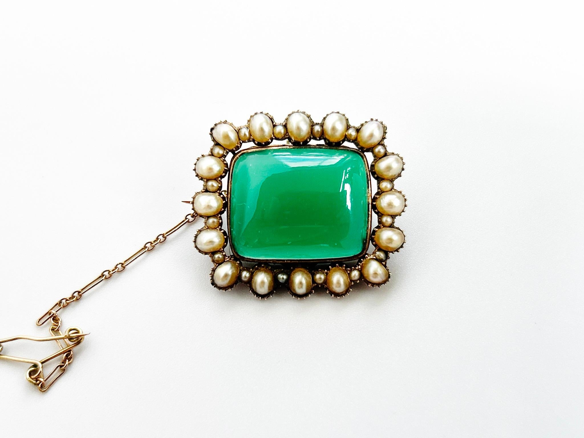 Georgian Chrysoprase and Seed Pearl Pendant/brooch/locket with a rectangular cabochon chrysoprase surrounded by a border of Natural Pearls and seed pearls in gold setting with glazed locket compartment to the reverse, 28mm x 25mm.