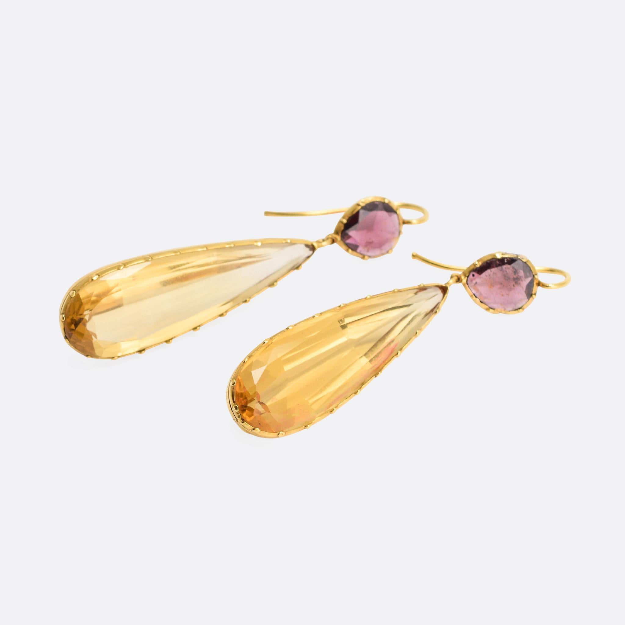 A sublime pair of Georgian drop earrings, each set with a long pear-shaped citrine dangling beneath a flat-cut almandine garnet - the total length is 5.2cm. The stones rest in cut down collet settings, very typical of the era; fashioned in 15 karat