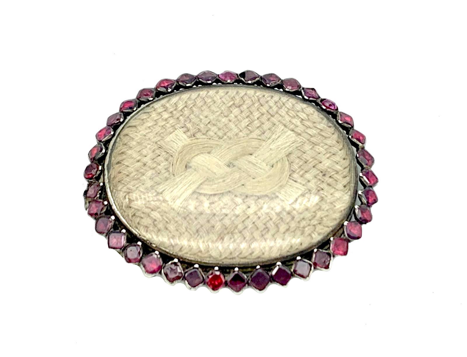 This Georgian Clasp was handcrafted in the last quarter of the 18th century. These kind of clasps were used for bracelets and for necklaces. The clasp is made out of silver and set with flat cut square garnets. Two of the garnets are chipped. Under