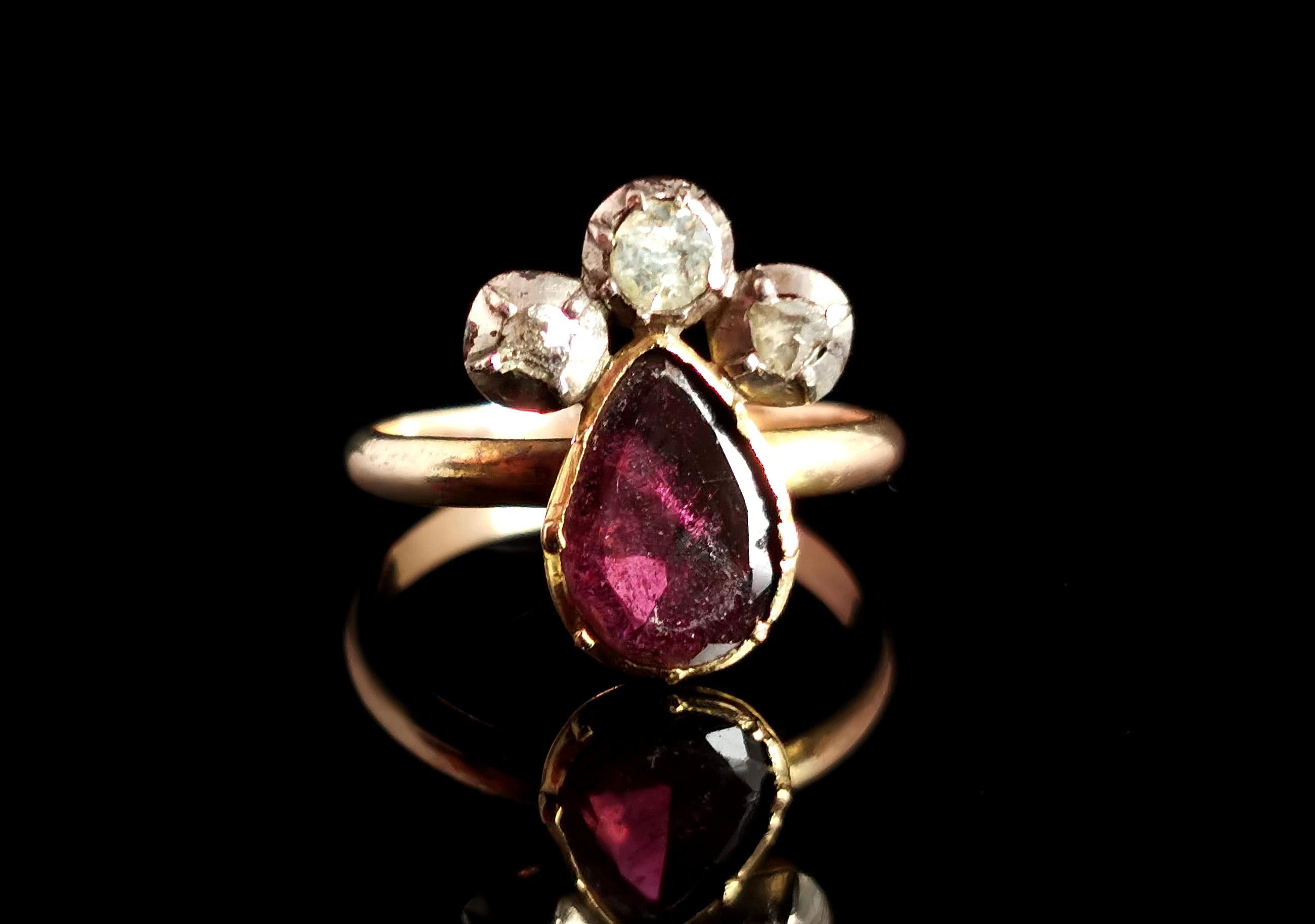 A beautiful, Georgian, late 18th century crowned heart ring.

It is made up of a pear shaped flat cut almandine garnet representing the heart and the crown is made up of pretty Rose cut diamonds collet set into silver.

I love the mysterious and