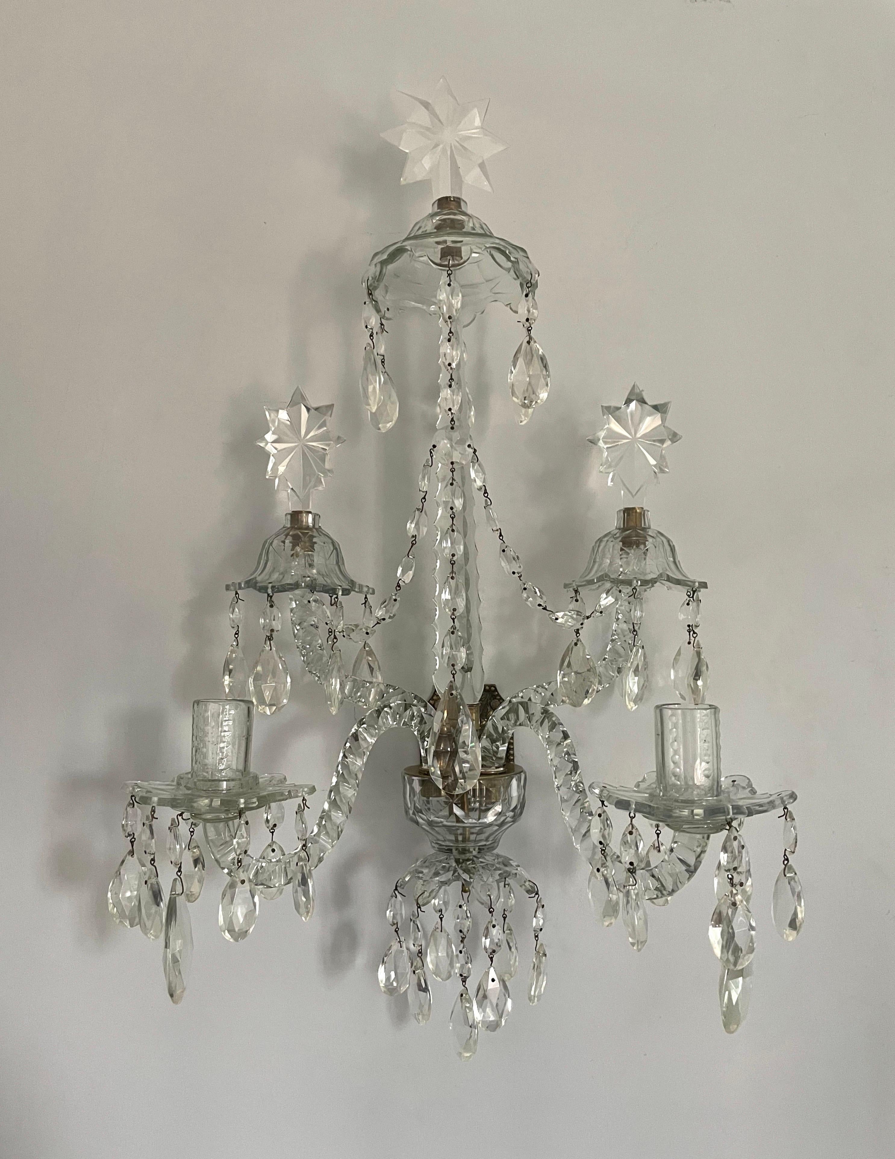 Exquisite, single English antique crystal sconce in the neoclassical style. 

This beautiful wall sconce consists of delicately hand-cut details throughout its structure. The center finial is crowned with an etched star as are two “swan neck” arms