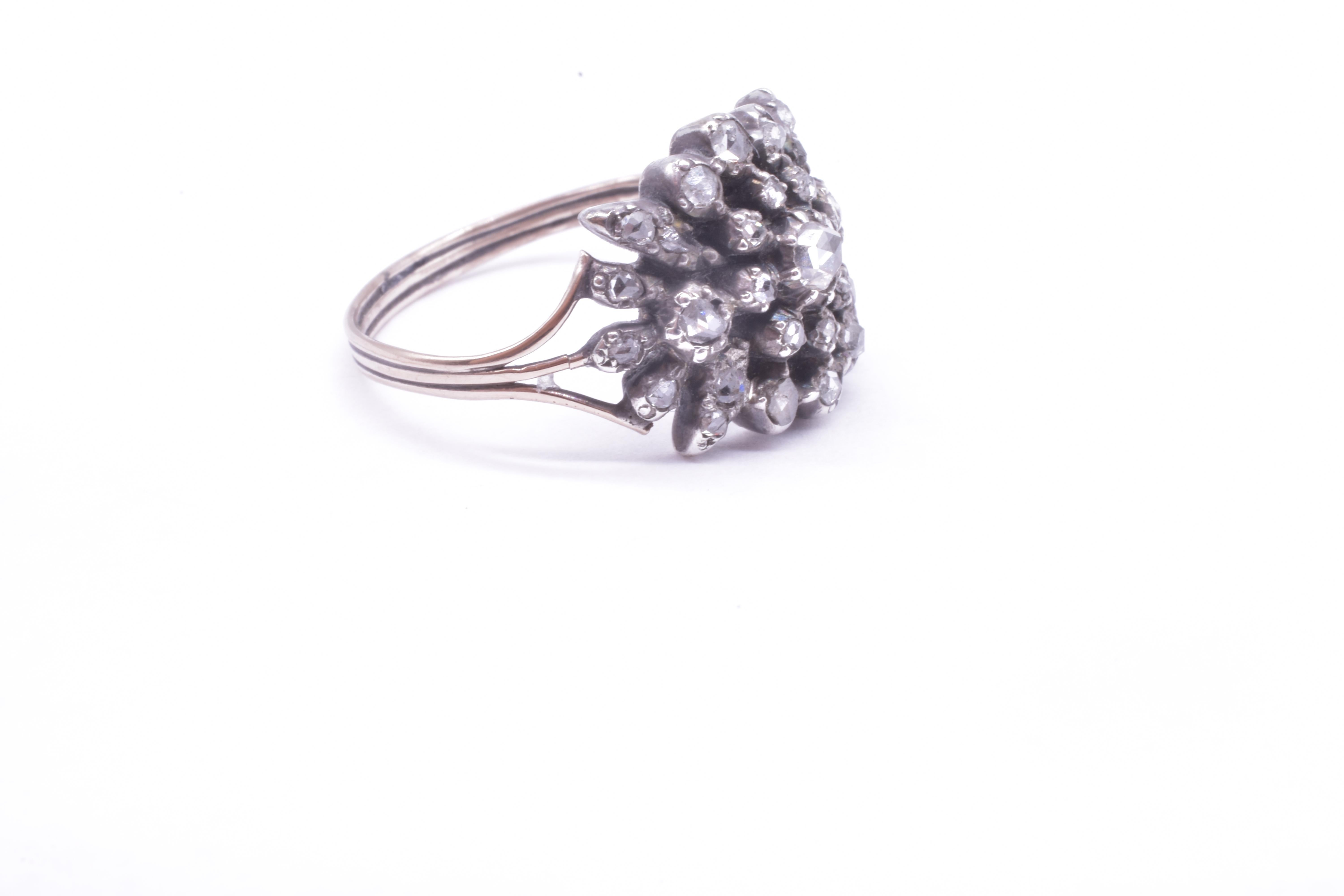 Georgian diamond ring in a snowflake motif set in silver with an 18K band will sparkle in sunlight and candlelight. Notice the gorgeous back, a work of art in and of itself. The ring back is cut down so that the metal is cut to fit the stones and